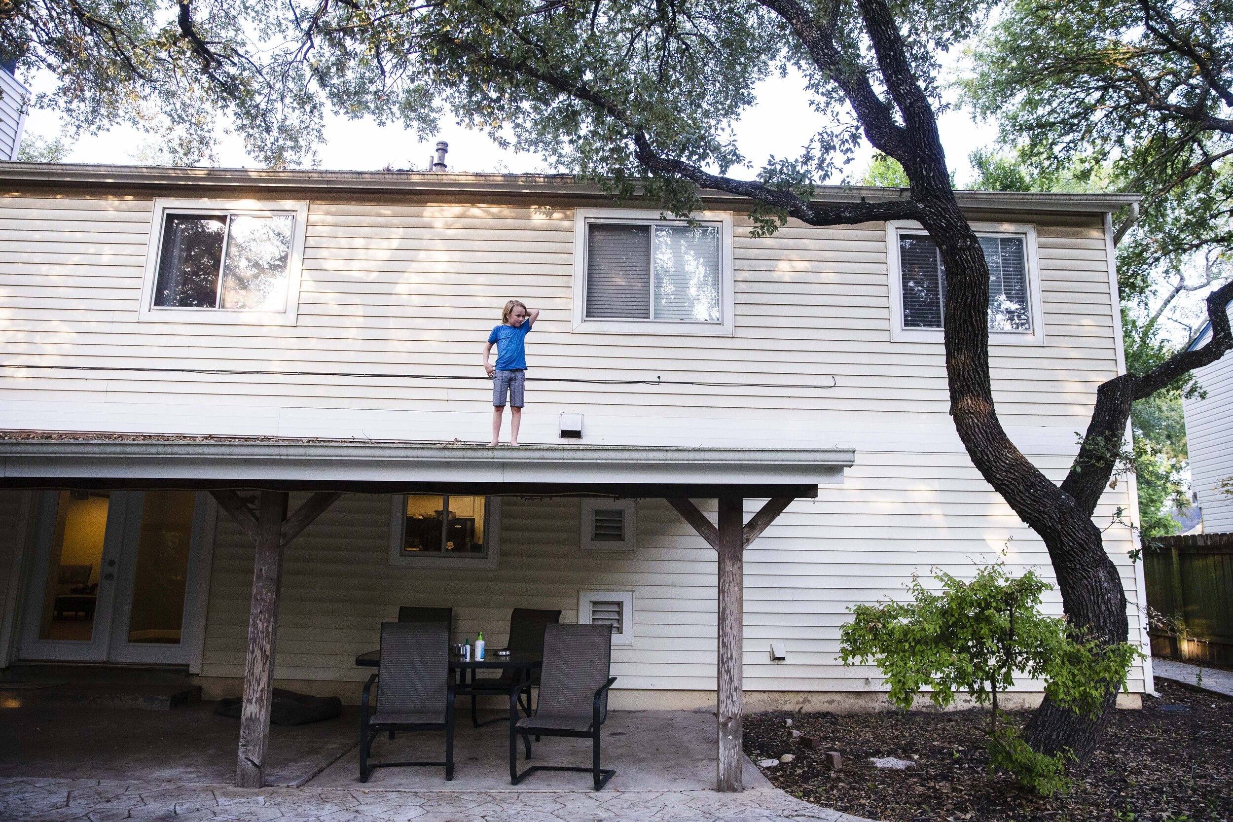  Keegan, a gender creative child, then 8, climbs atop his family home while playing outside in Austin, Texas, U.S., August 22, 2018. Since the age of 4, Keegan had been prone to dressing in traditional female clothing, asking to wear dresses to pre-s