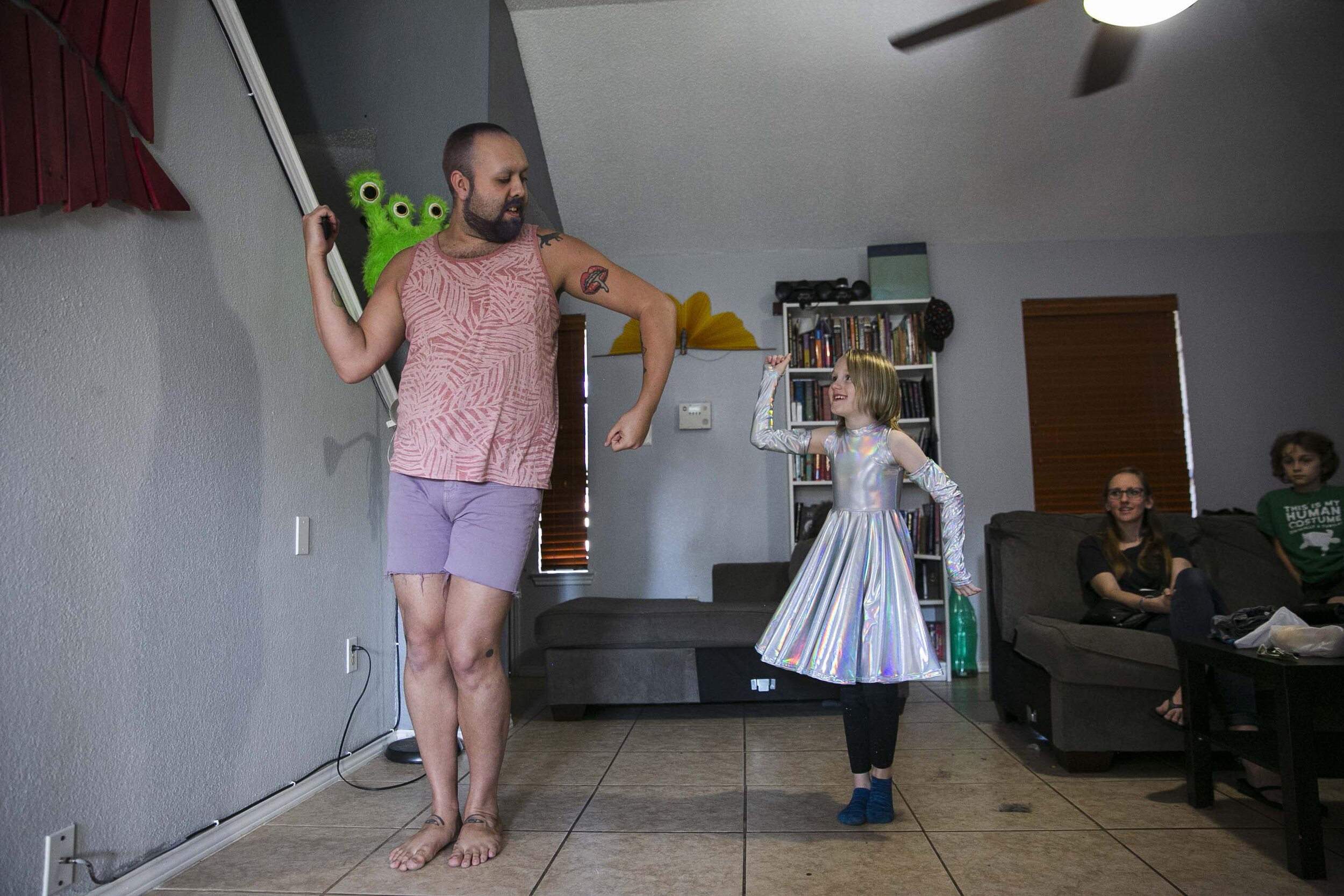 Under the mentorship of the drag queens, Keegan’s drag life has blossomed.  Robby, a drag queen, then 25, left, helps Keegan, a gender creative child, then 8, middle, rehearse for his upcoming inaugural drag performance at the home Robby shares with