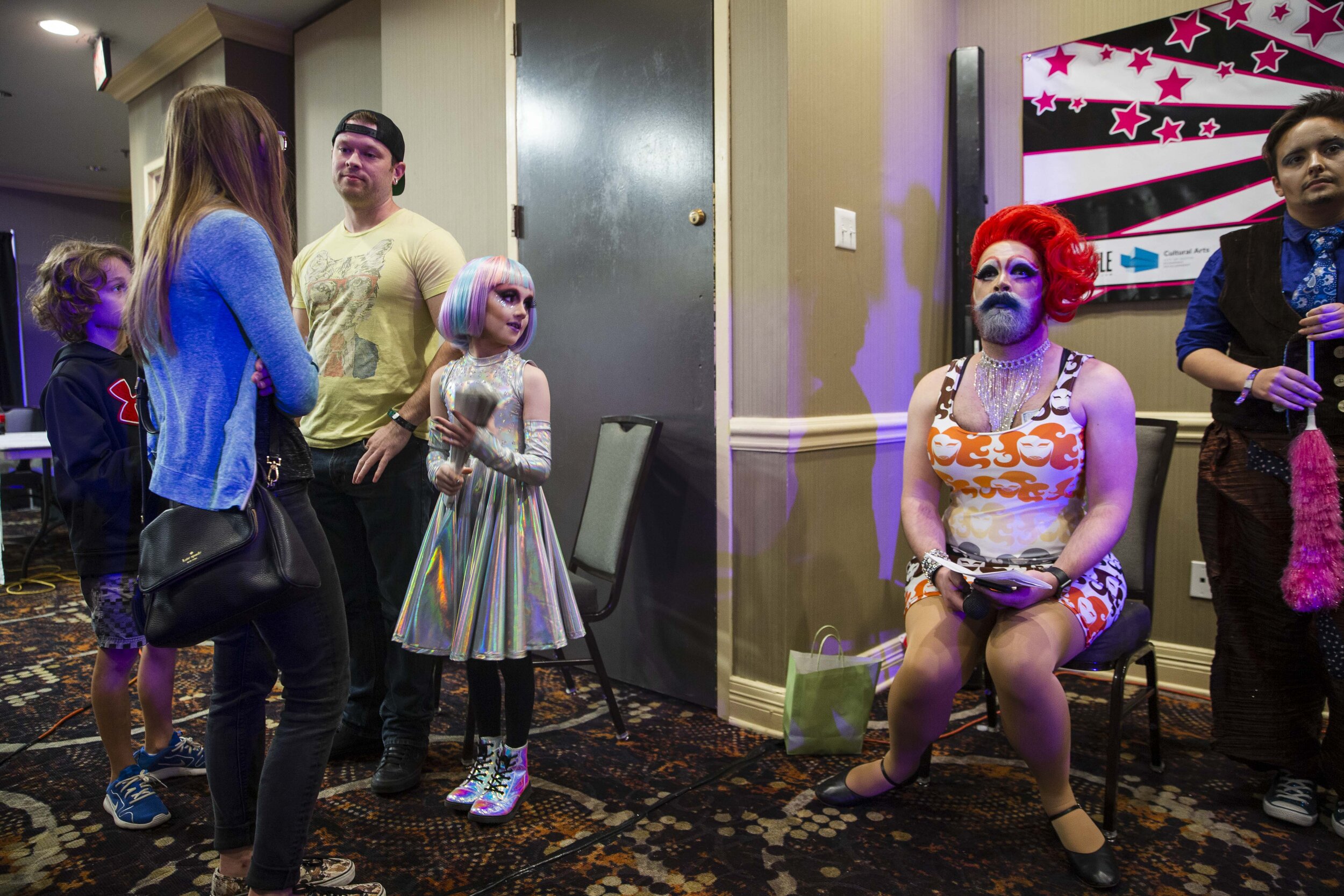  Keegan, a gender creative child, drag name KweenKeekee, then 8, middle, accompanied by his family, glances at another performer during the Austin International Drag Fest 2018 in Austin, Texas, U.S., Nov. 18, 2018. 