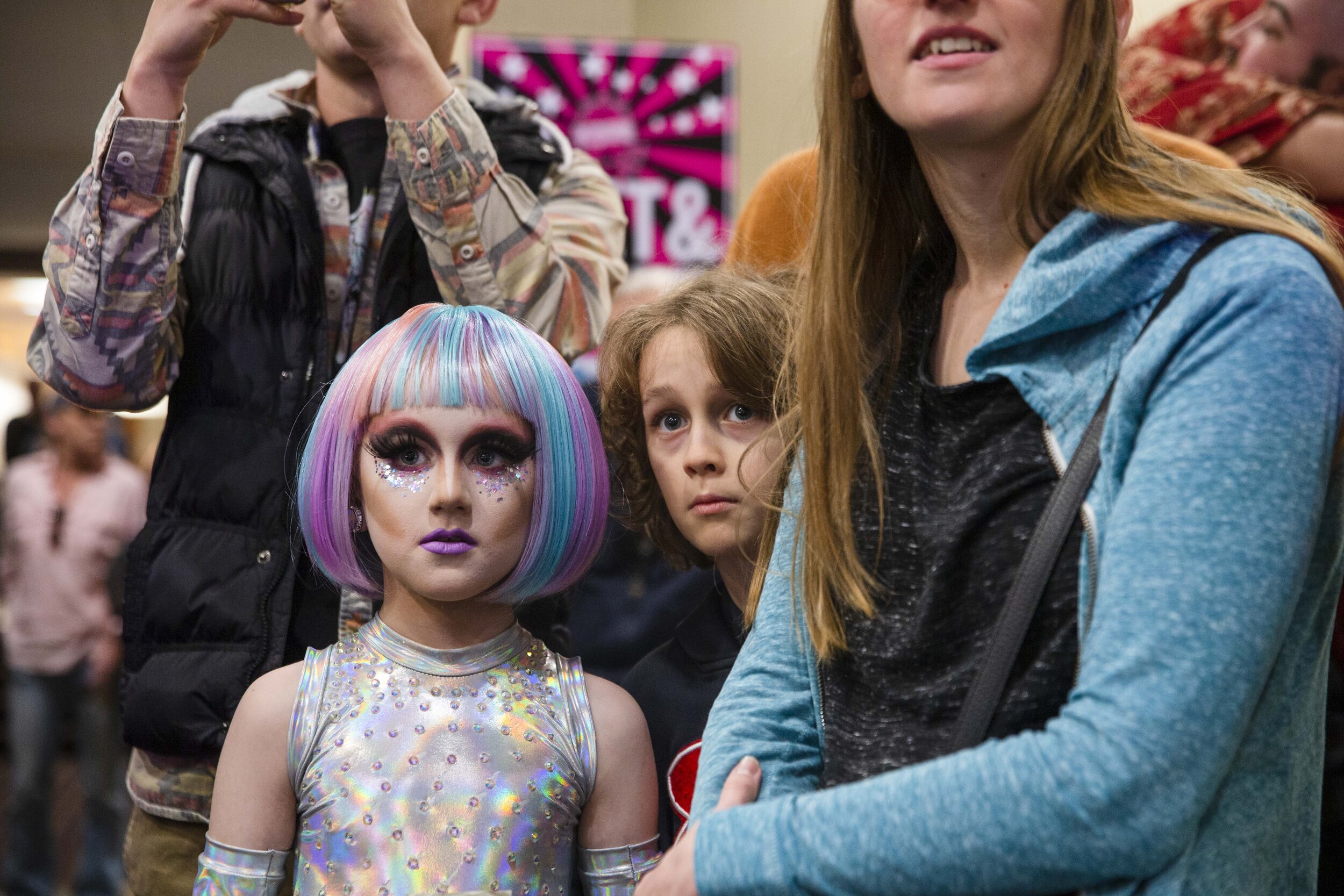  Keegan, a gender creative child, then 8, left, and his brother Noah, 10, middle, accompanied by his family, look on after arriving at the Austin International Drag Fest 2018 in Austin, Texas, U.S., Nov. 18, 2018.  