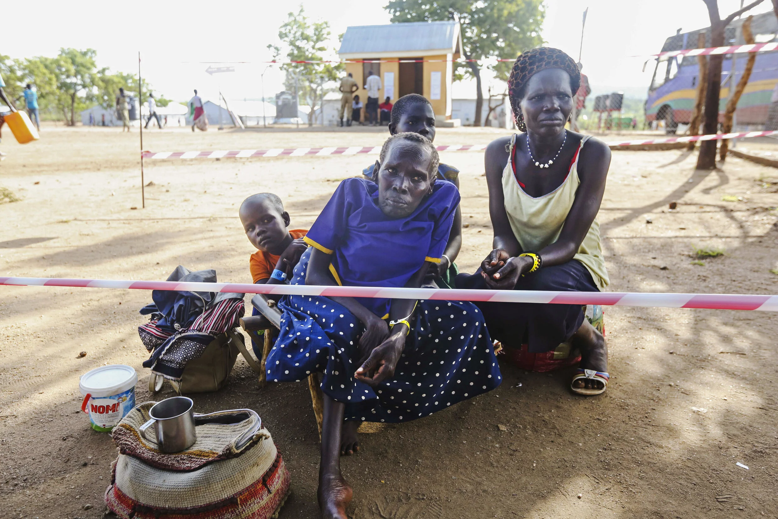 Newly arrived South Sudanese refugees wait for a wheelchair at the reception center at the Imvepi Refugee camp on Friday, 23 June, 2017 in Northern Uganda. The fastest growing refugee crisis in the world, Uganda is now hosting now more than 1.2 mil