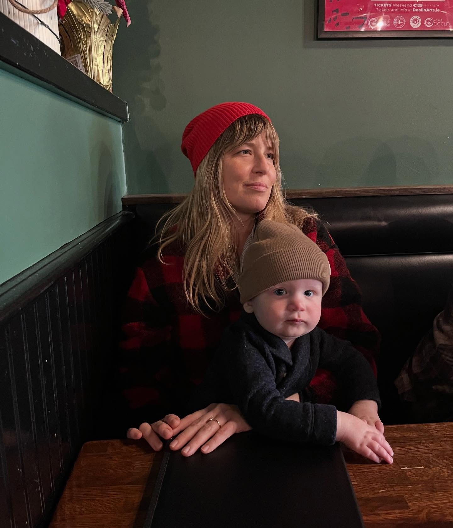 Portrait of Tired Mother with Child at Boston Pub.