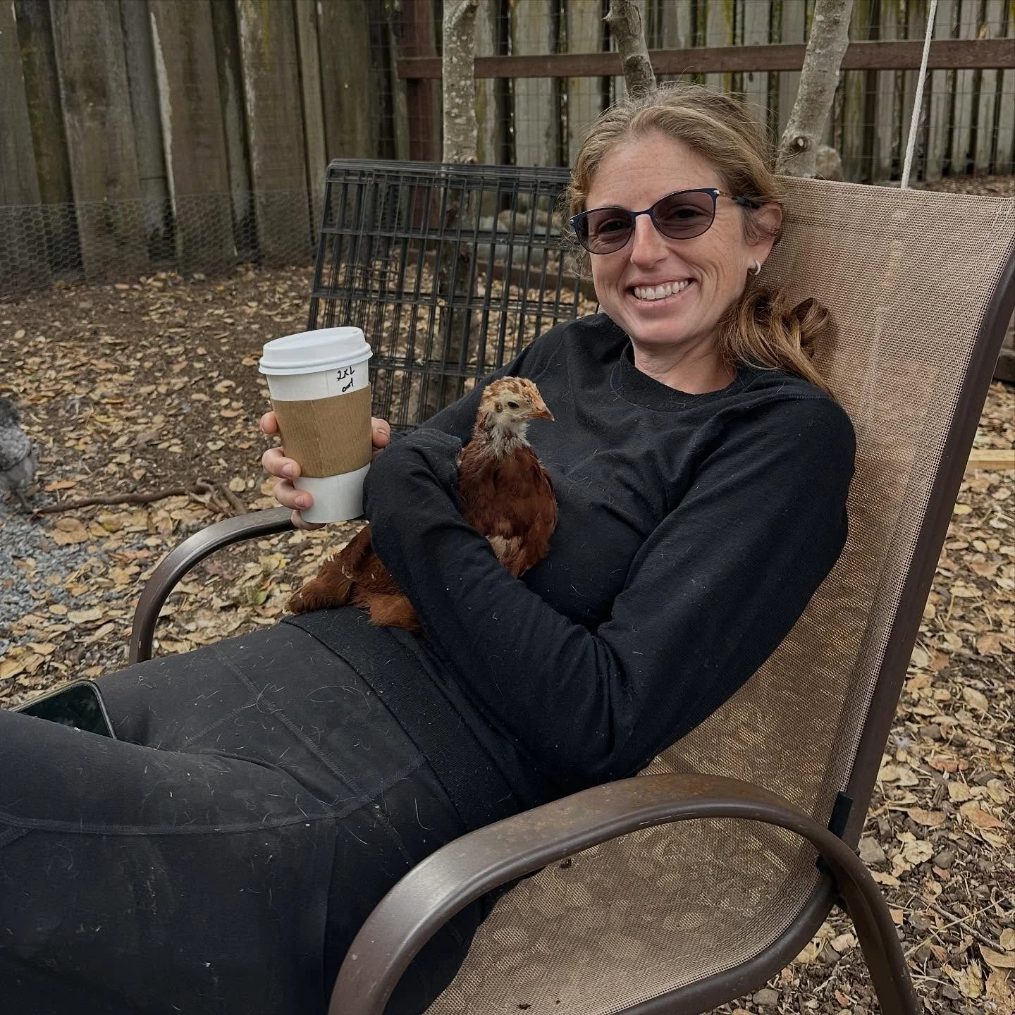 Just a woman and her chicken. And a coffee. And friends. And a little dog.