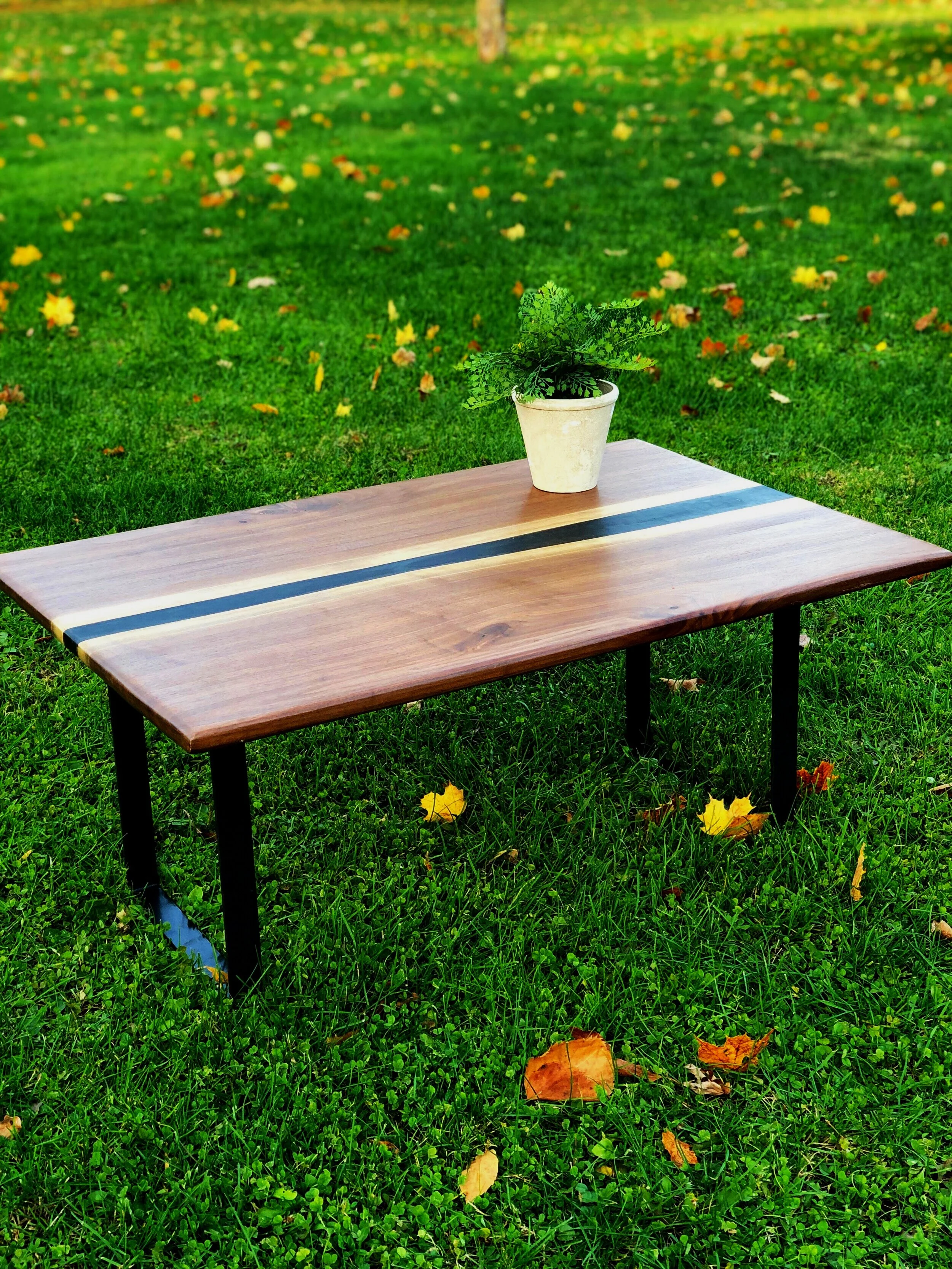 Walnut black epoxy river table.