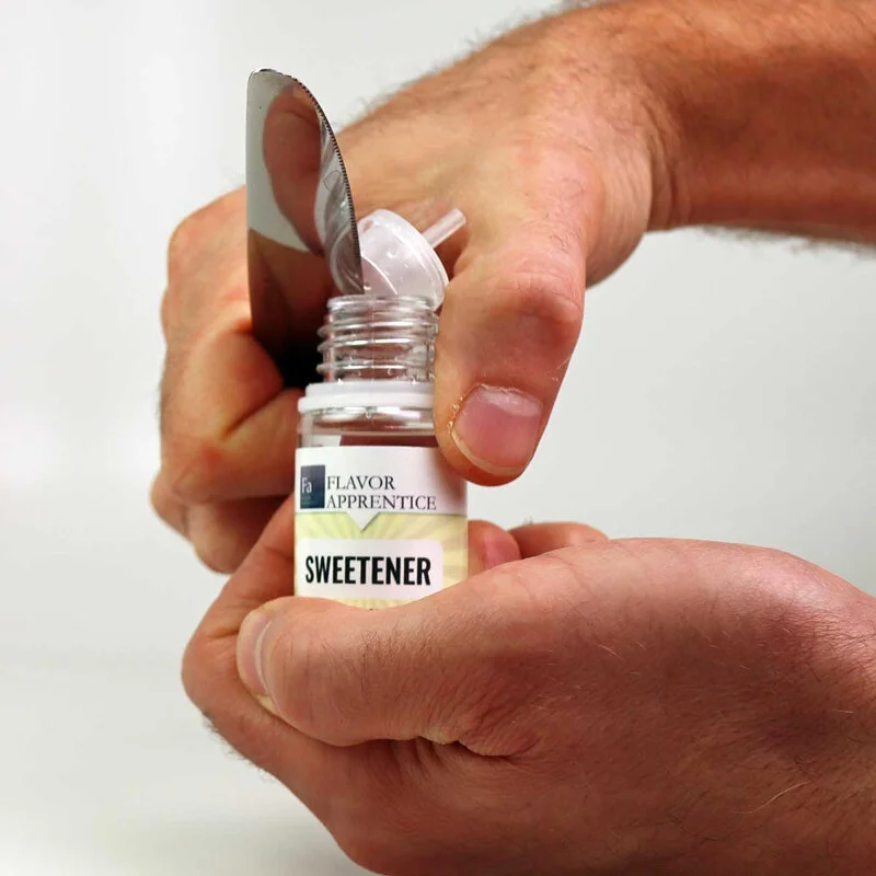 You'll want to place the edge of the knife in the seam between the cap and the bottle, then pry upwards.