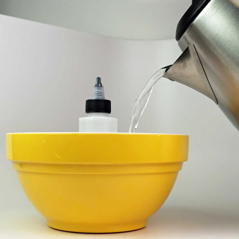 You'll want to fill the bowl with hot, but not boiling water, until about the halfway mark on the bottle of eJuice. If you're not using the recommended bottle, this step will warp or slightly melt your bottle.