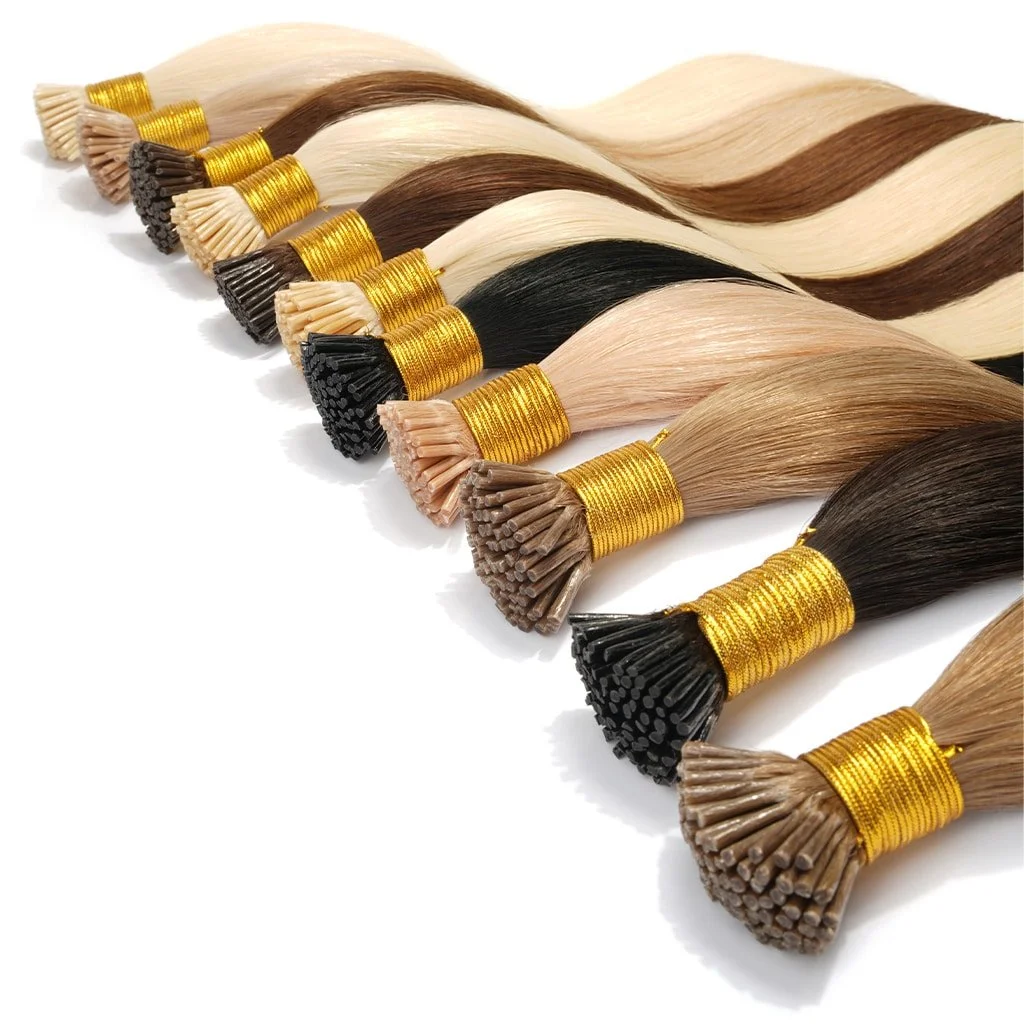 Multiple bundles of hair extensions in various shades of blonde, brown, black, and beige, each wrapped with golden bands, arranged in a row on a white background.