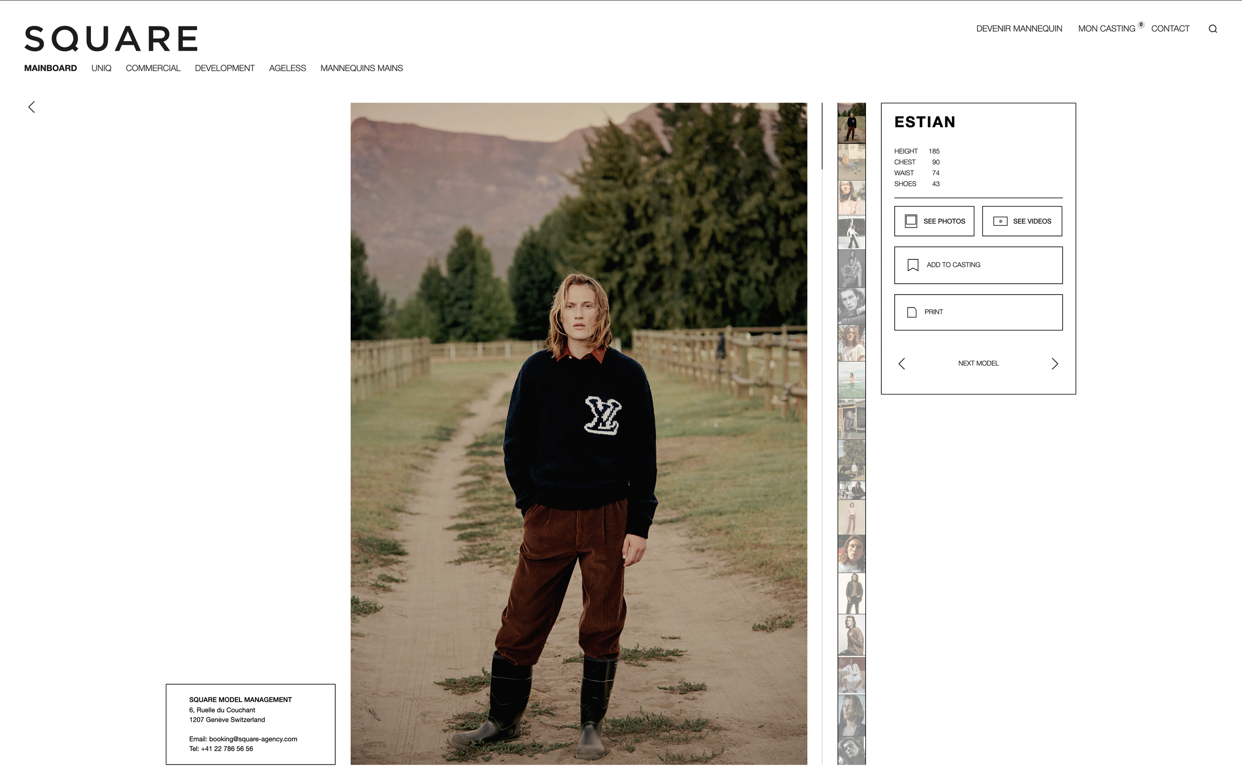 Une femme debout sur un chemin en plein air, avec des montagnes et des arbres en arrière-plan, portant un pull noir avec un logo blanc LV, des pantalons marron et des bottes en caoutchouc.