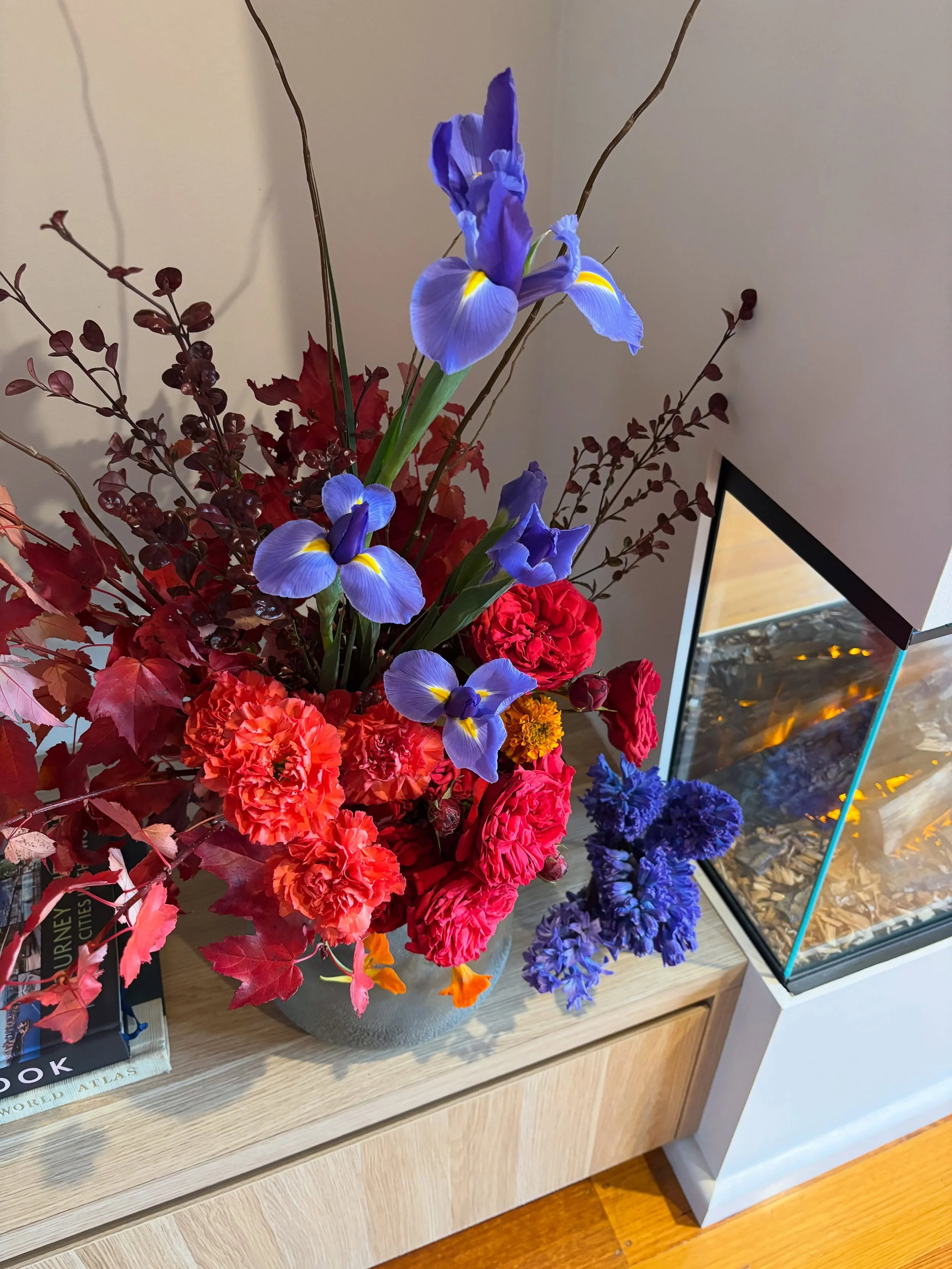 Peek my homegrown nasturtium for an extra pop of orange!

Do we like the arrangement with the iris or without?
I thought I loved the arrangement pre - with all the orange &amp; red, but as soon as I added the iris it felt more complete. I love the co