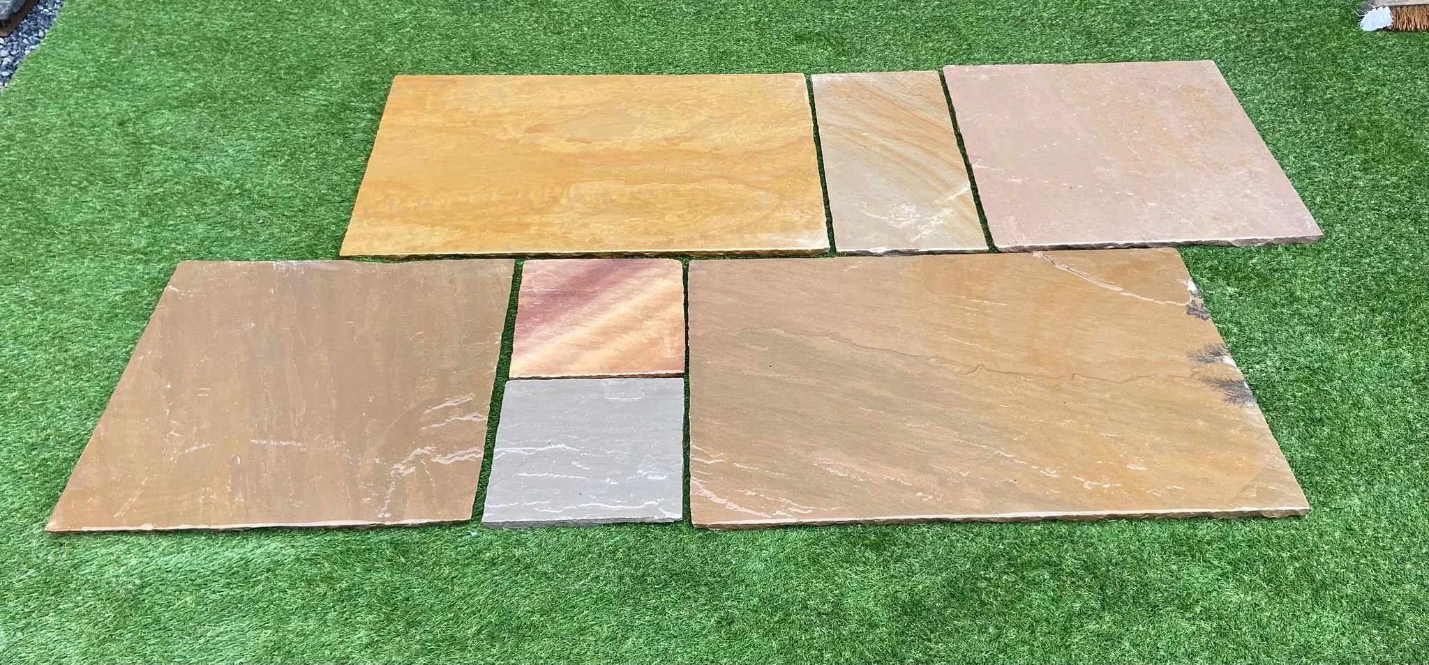 Image of Shanlieve Stones Camel Dust Natural Sandstone Paving lying on grass bed in Shanlieve Stones Show area in Newry, Countt Down