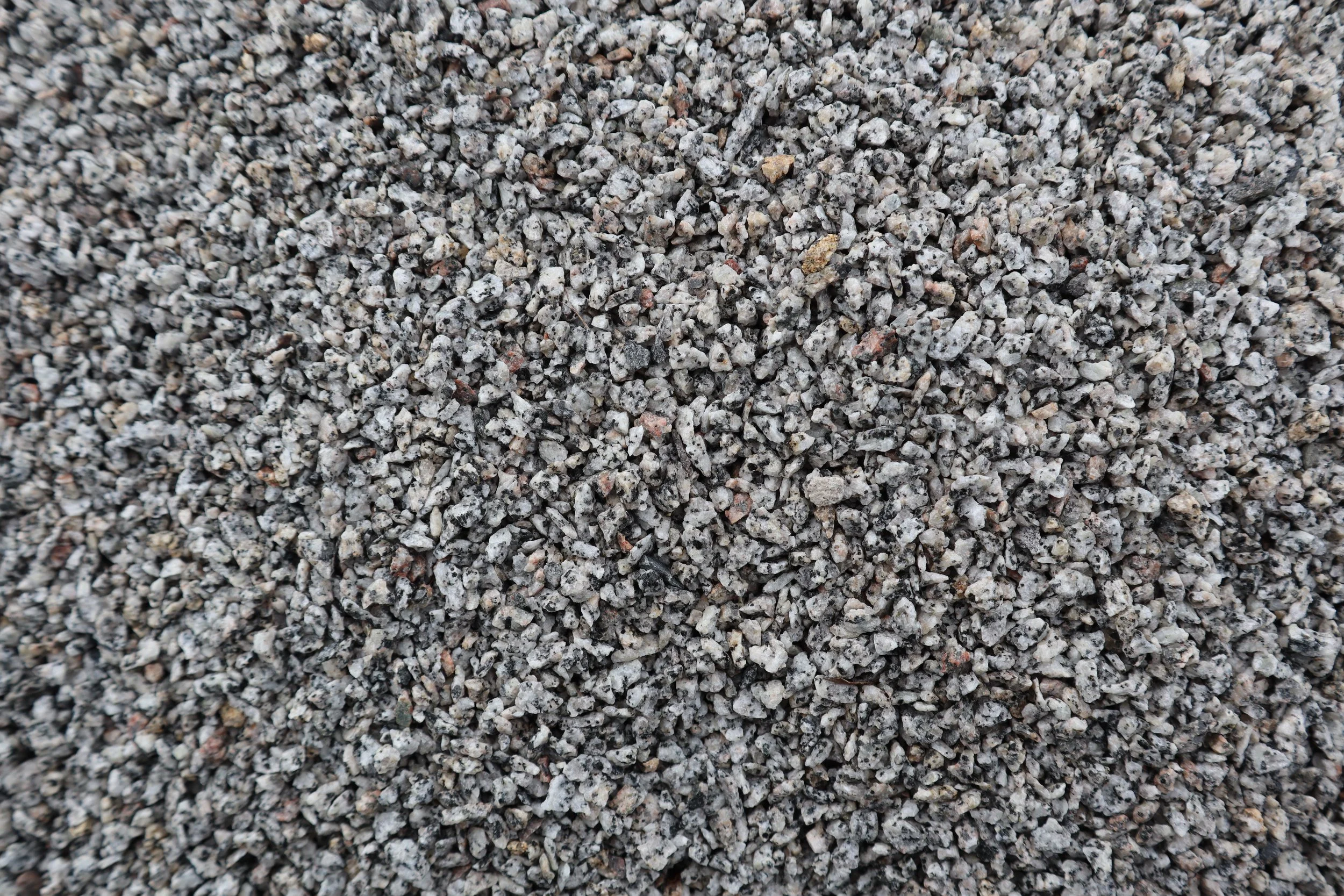Image shows a picture of Shanlieve Stones Grey Granite Dash 3-6mm range. The picture is a close up of the dash which displays all the colours in the average range of the dash. Granite Dash can be supplied to the UK & Ireland by Shanlieve Stone 