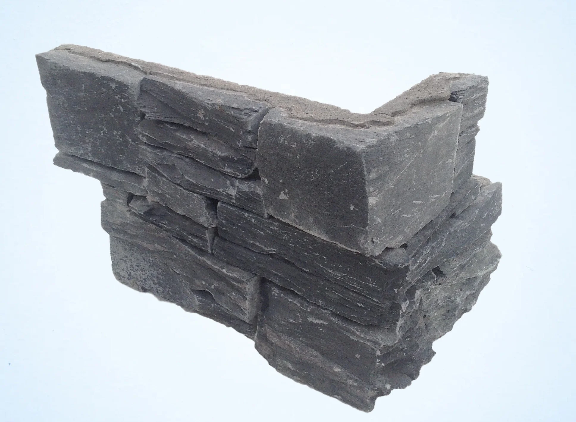 Image of Slate corner stone that Shanlieve supply from Tier Clad. It is a corner piece which showcases the style of the corners and their precision finish as showcased in Shanlieve Stones Yard in Newry, Northern Ireland