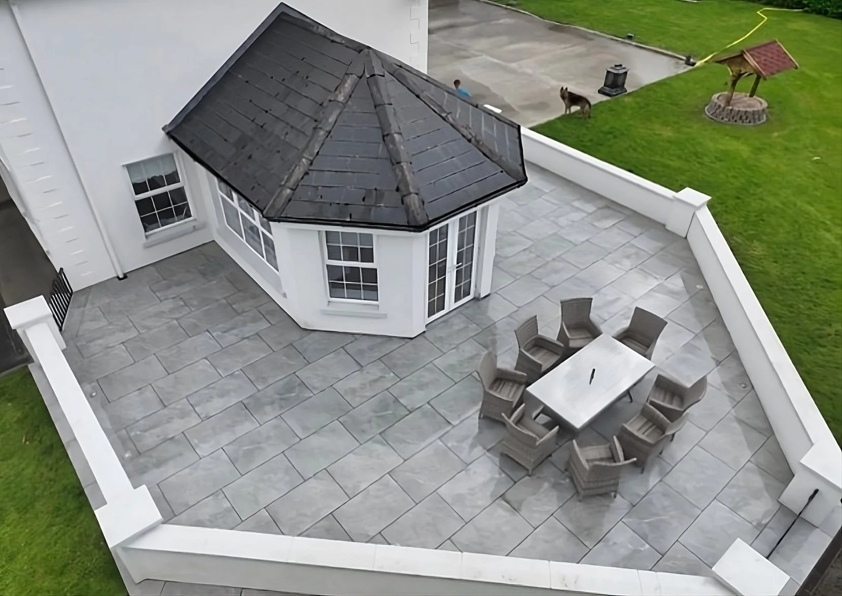 Image of Shanlieve Stones Italian Grey Porcelain Paving in the back garden of a house. Paving supplied by Shanlieve Stone from their quarry in Newry 