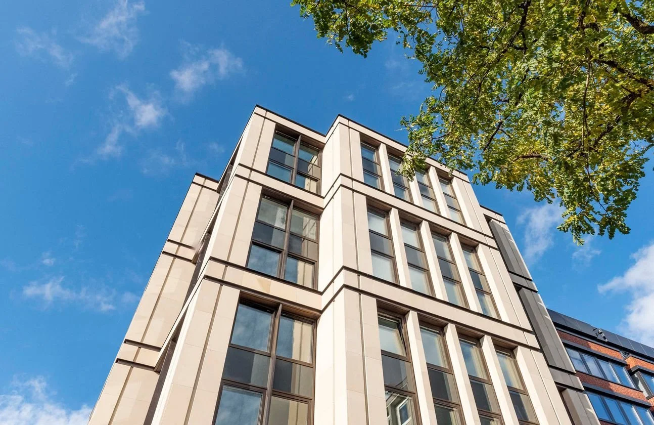 Image of a large commercial building with a stone facade used to face the outside of the building