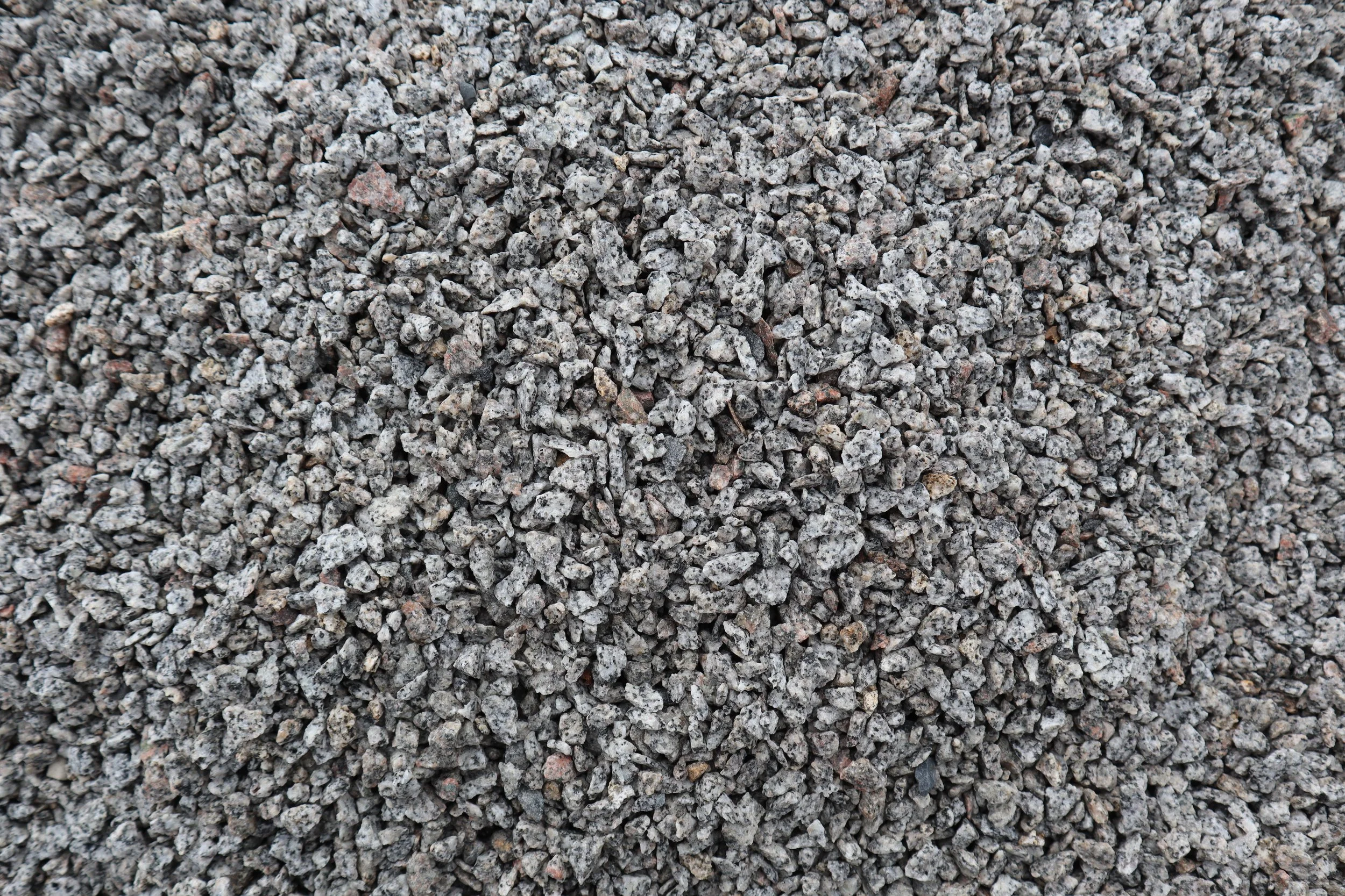 Image shows a close up picture of Shanlieve Stones 6-10mm granite dash range in a typical colour range which is predominantly Grey with some brown and red hues through the mix. The Granite Dash is supplied by Shanlieve Stone to the UK & Ireland