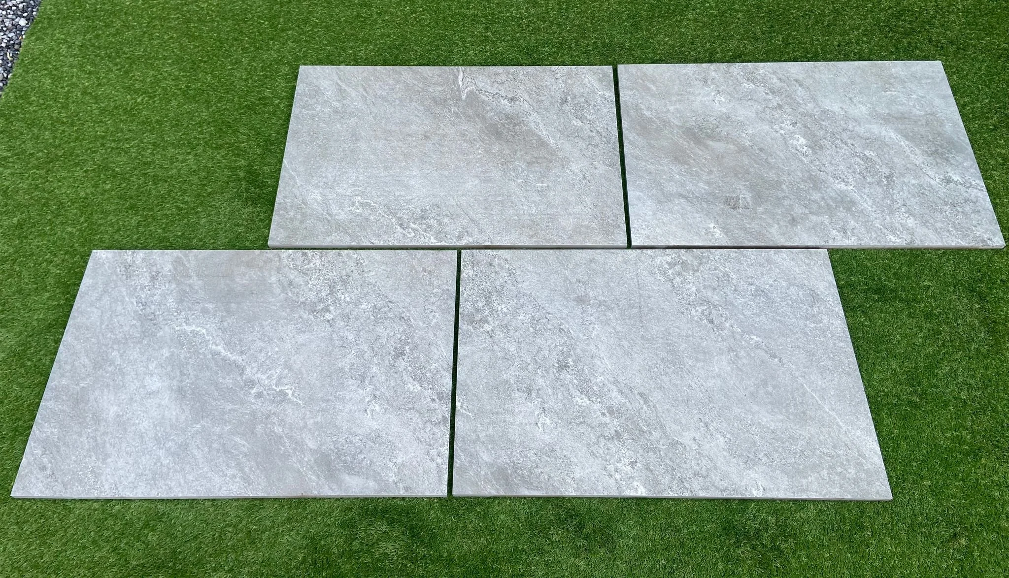 Image of our grey porcelain as supplied by Shanlieve Stone sitting on a grass background in Shanlieve Stones display yard in Newry, Northern Ireland