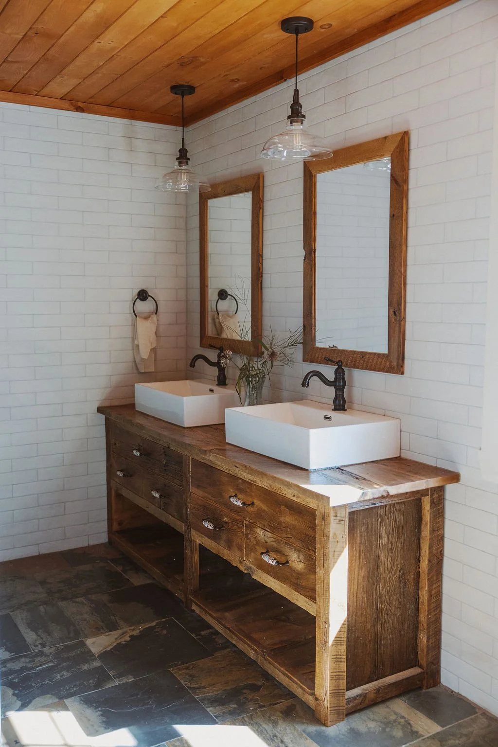 Custom reclaimed hemlock bathroom vanity by Tyler Buchanan with slate floor