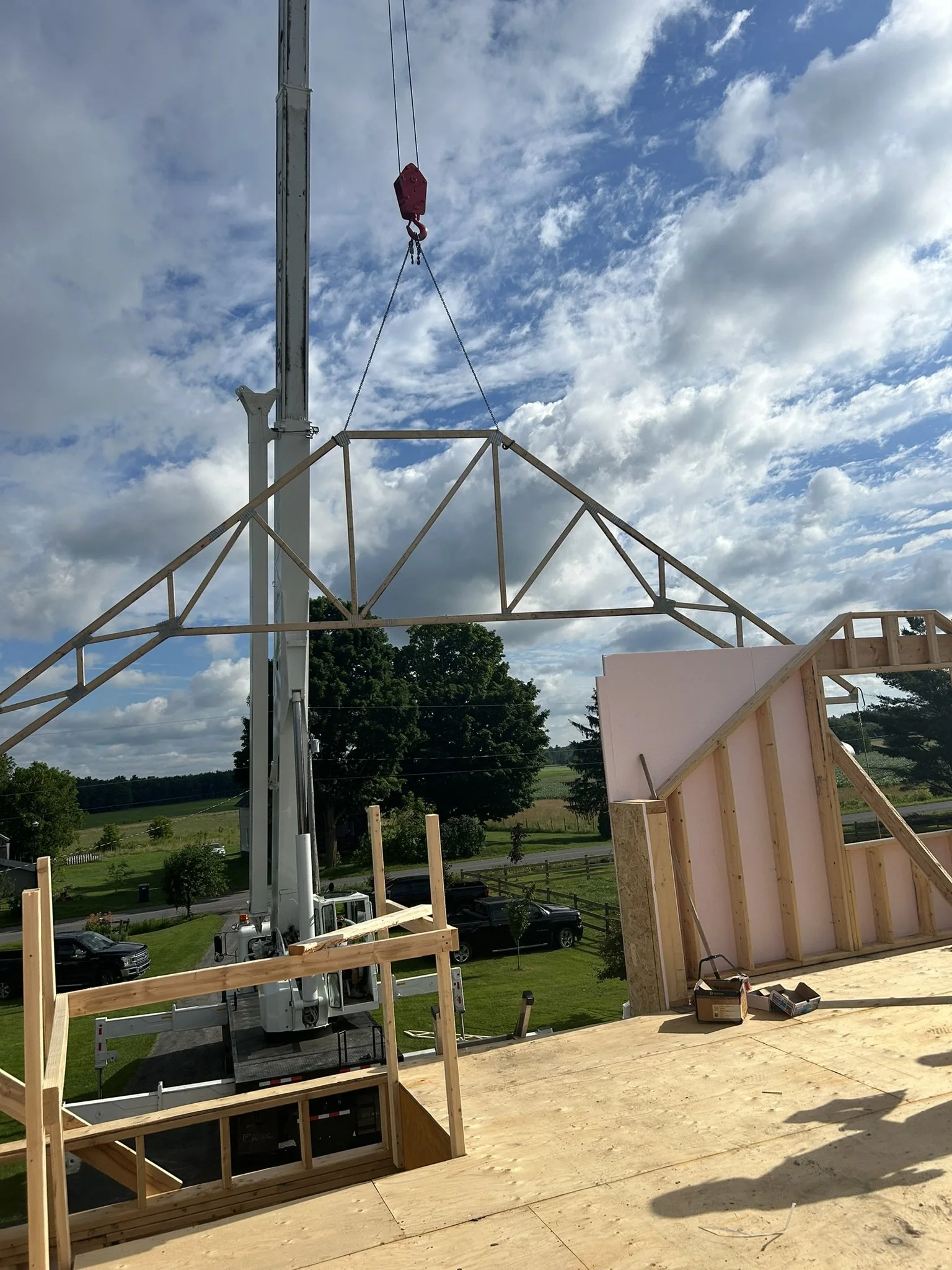 Construction progress of 900 square foot farmhouse addition showing exposed beams and framing