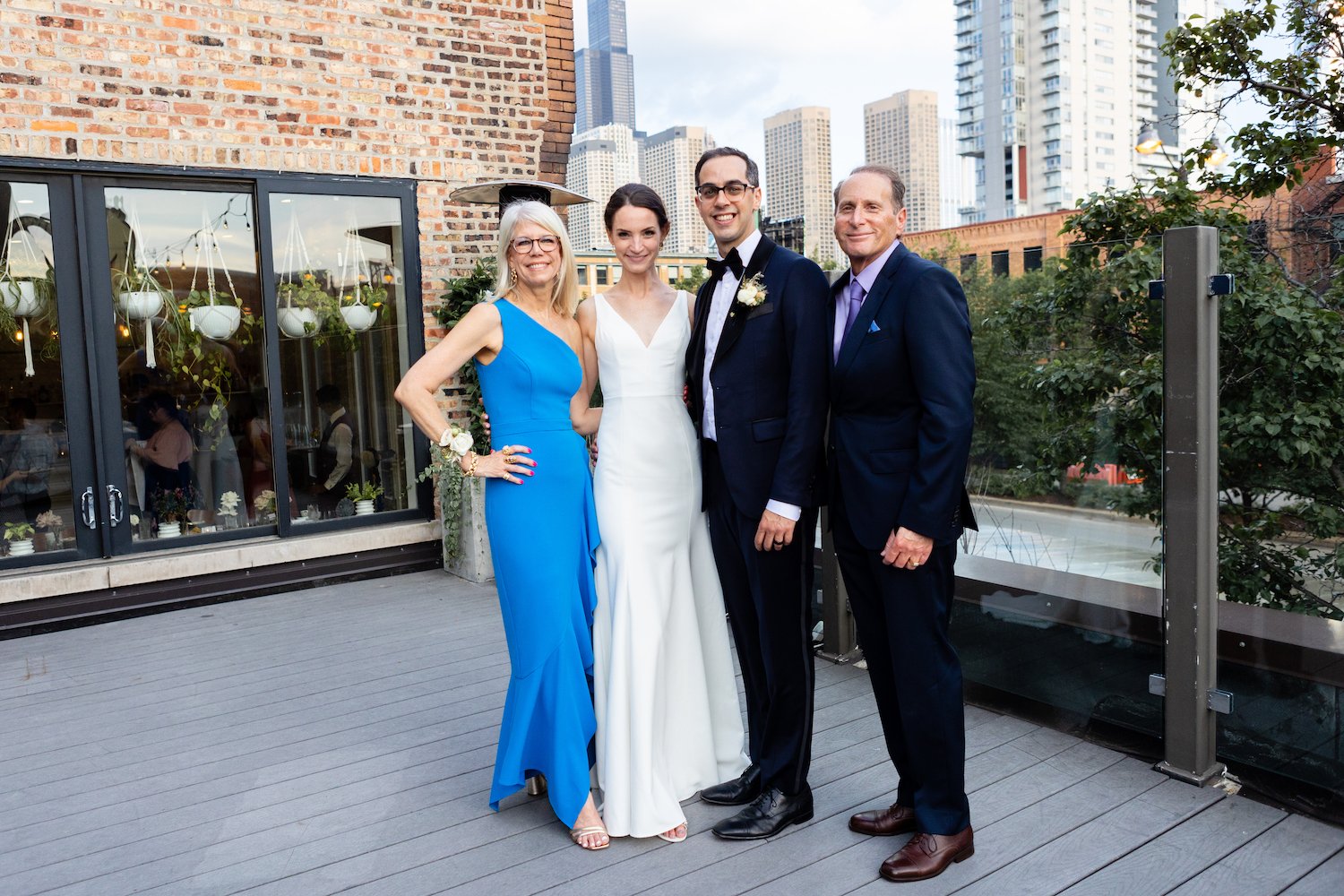 Bride_and_groom_with_parents_Chicago_rooftop.jpg