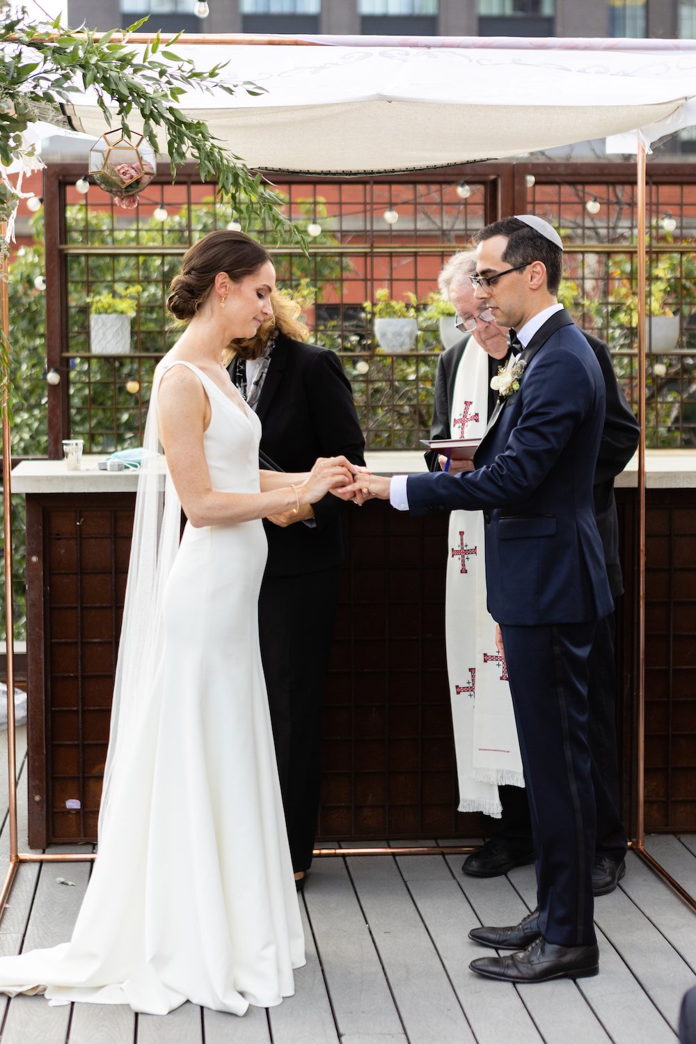 Bride_and_groom_exchanging_rings_under_huppah_chicago.jpg