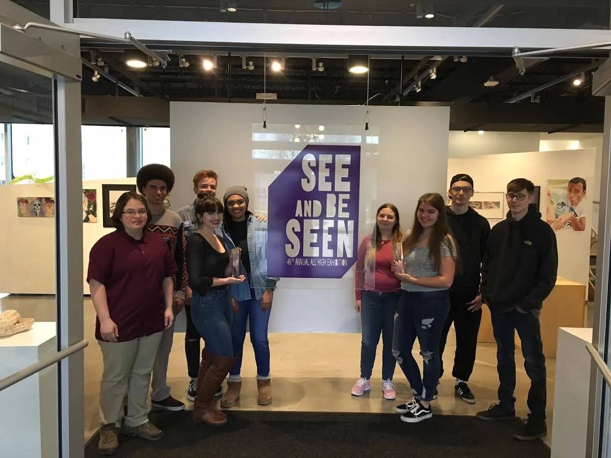 Plexiglass See and Be Seen cut-out hung at exhibit. Photo taken with class and Addy Awards