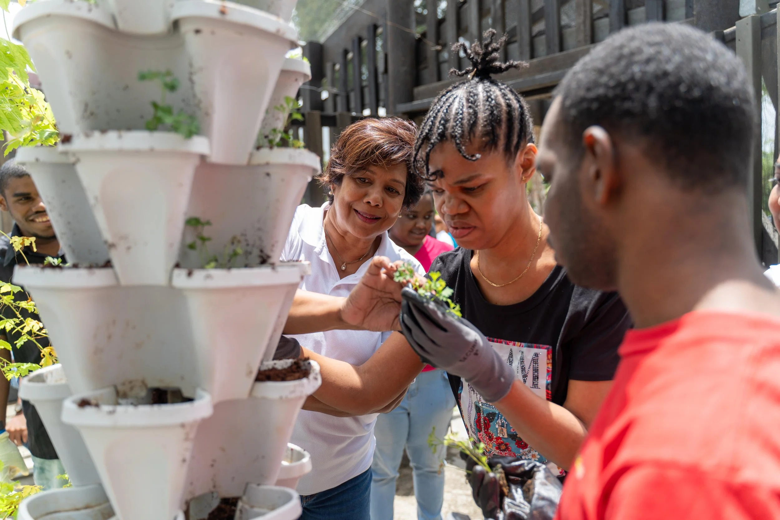 Shavindra Tewarie-Singh, IGT People & Transformation Regional Senior Manager for the Caribbean, teams up with the ASTT adult recreation group to plant seedlings at Autism Place in D’Abadie, as part of IGT’s Global Giving Month activities on 16th May.