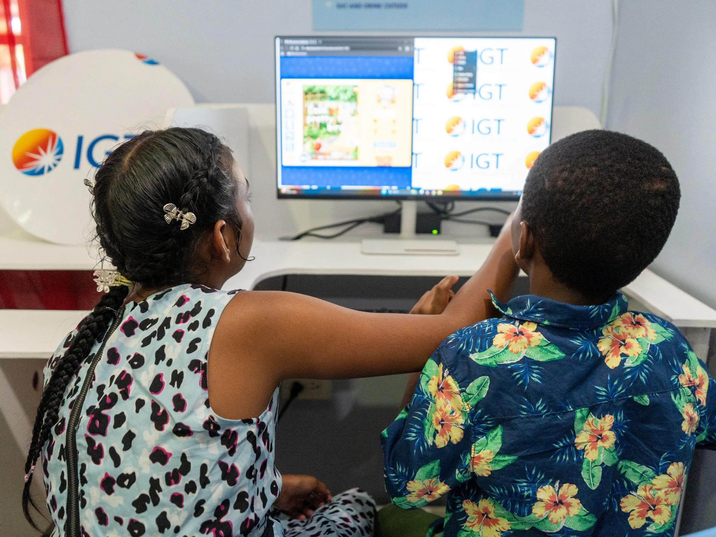Children from Casa de Corazon explore educational software on the desktops in their newly equipped computer lab, donated through the IGT After School Advantage Programme.