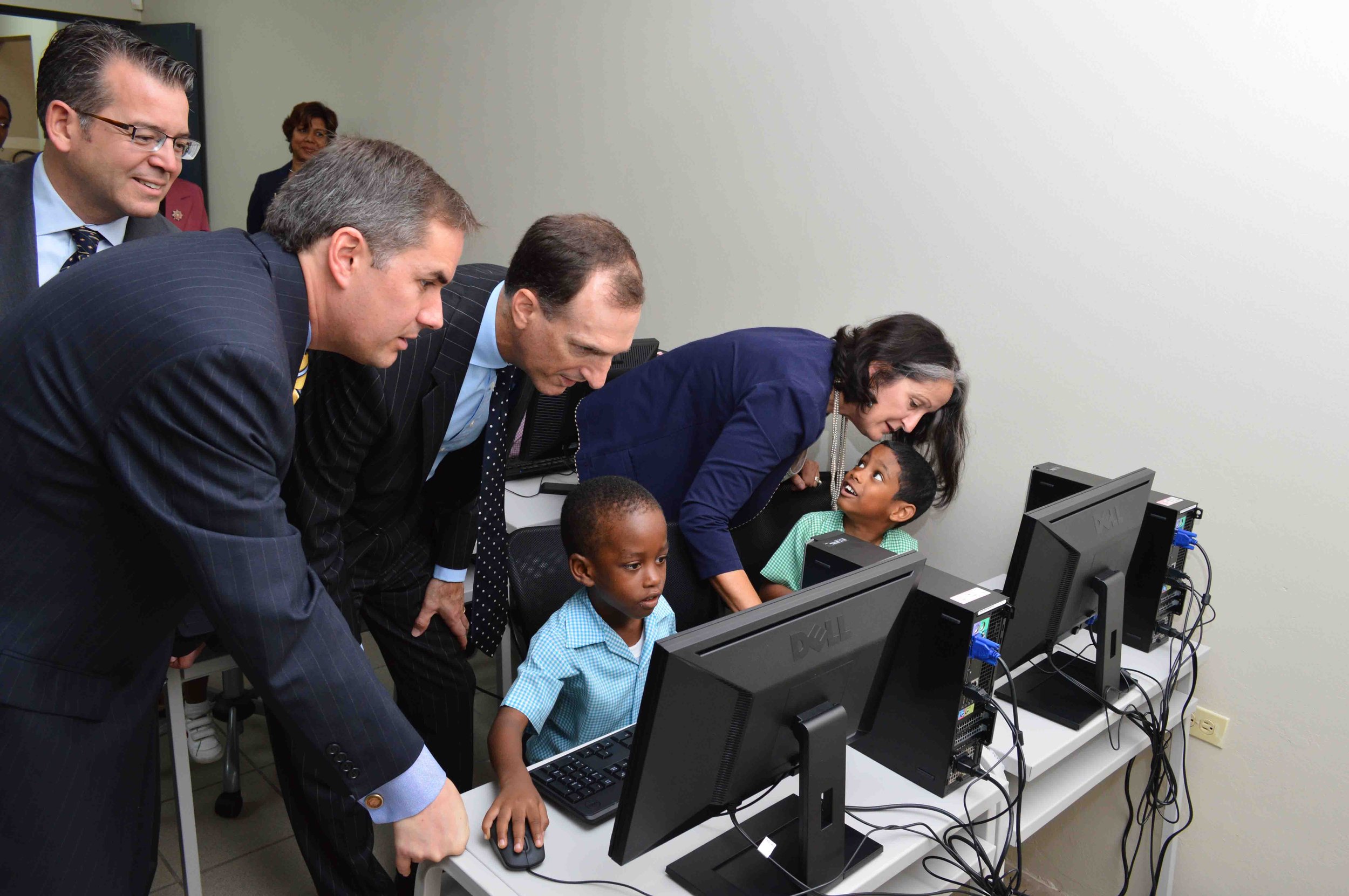  IGT Executives initialising donated hardware for children in underserved communities in 2013. SWF&CO has partnered with IGT since its inception in Trinidad and Tobago.  