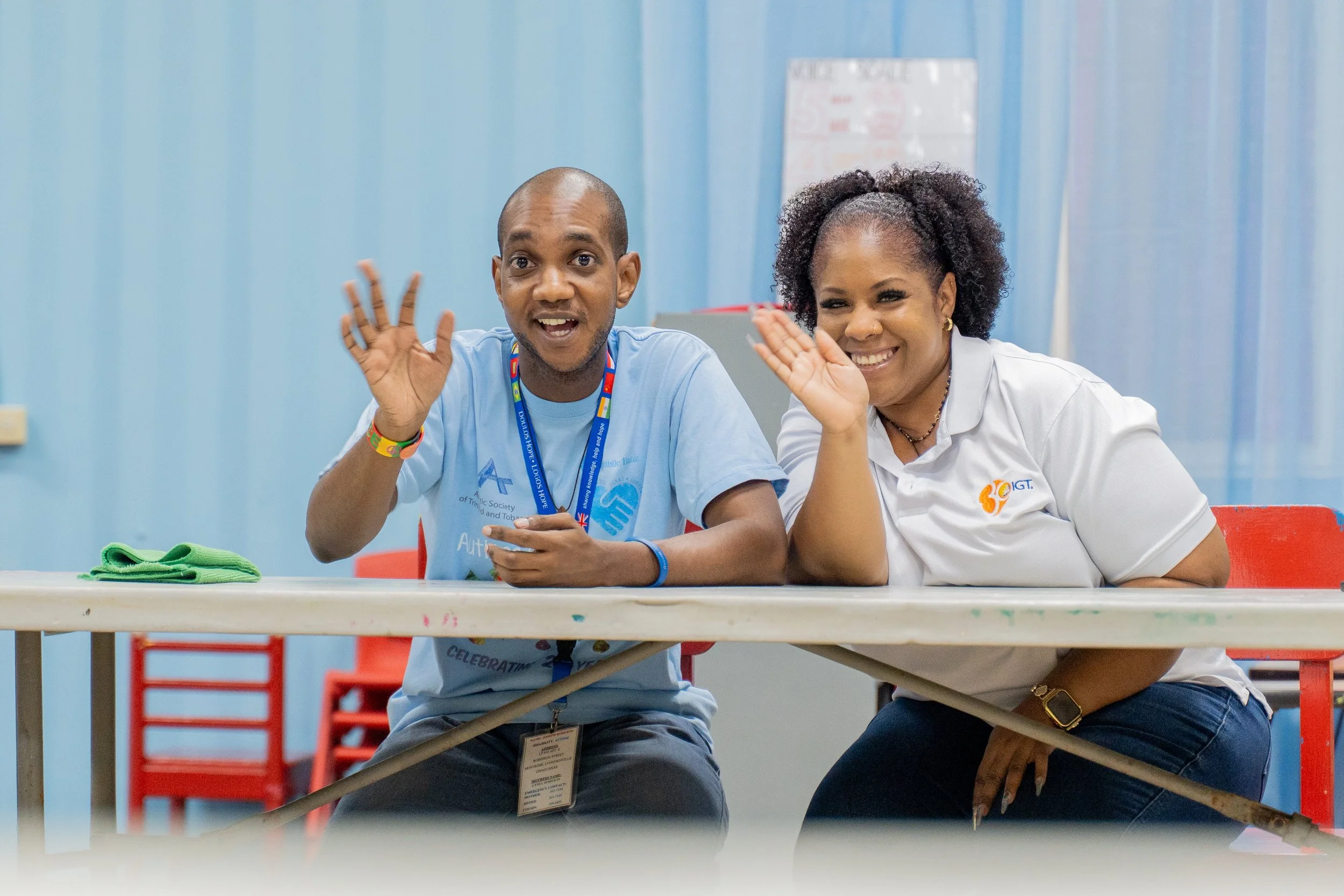 Joseph Roberts of the ASTT adult recreation group and Kandice Boisson, IGT Draw Coordinator, share a cheerful wave before kicking off IGT’s Global Giving Month activities at Autism Place in D’Abadie on 16th May.