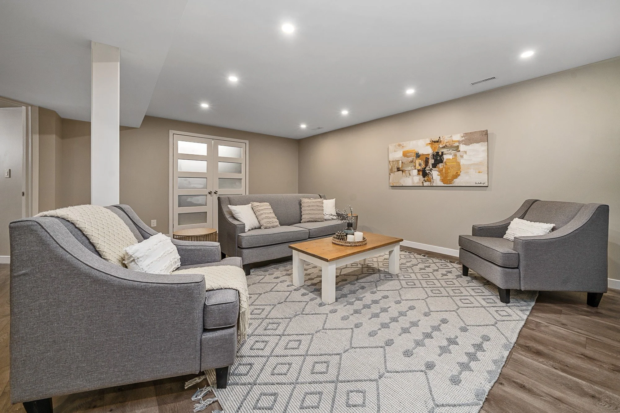 Finished basement living space by Pure Carpentry Co.