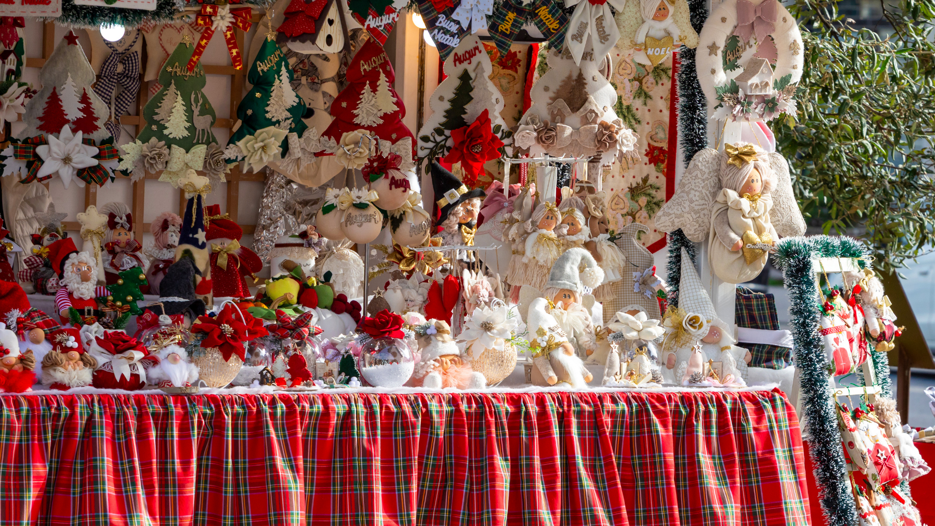 Holiday market vendors selling gifts and handmade crafts.
