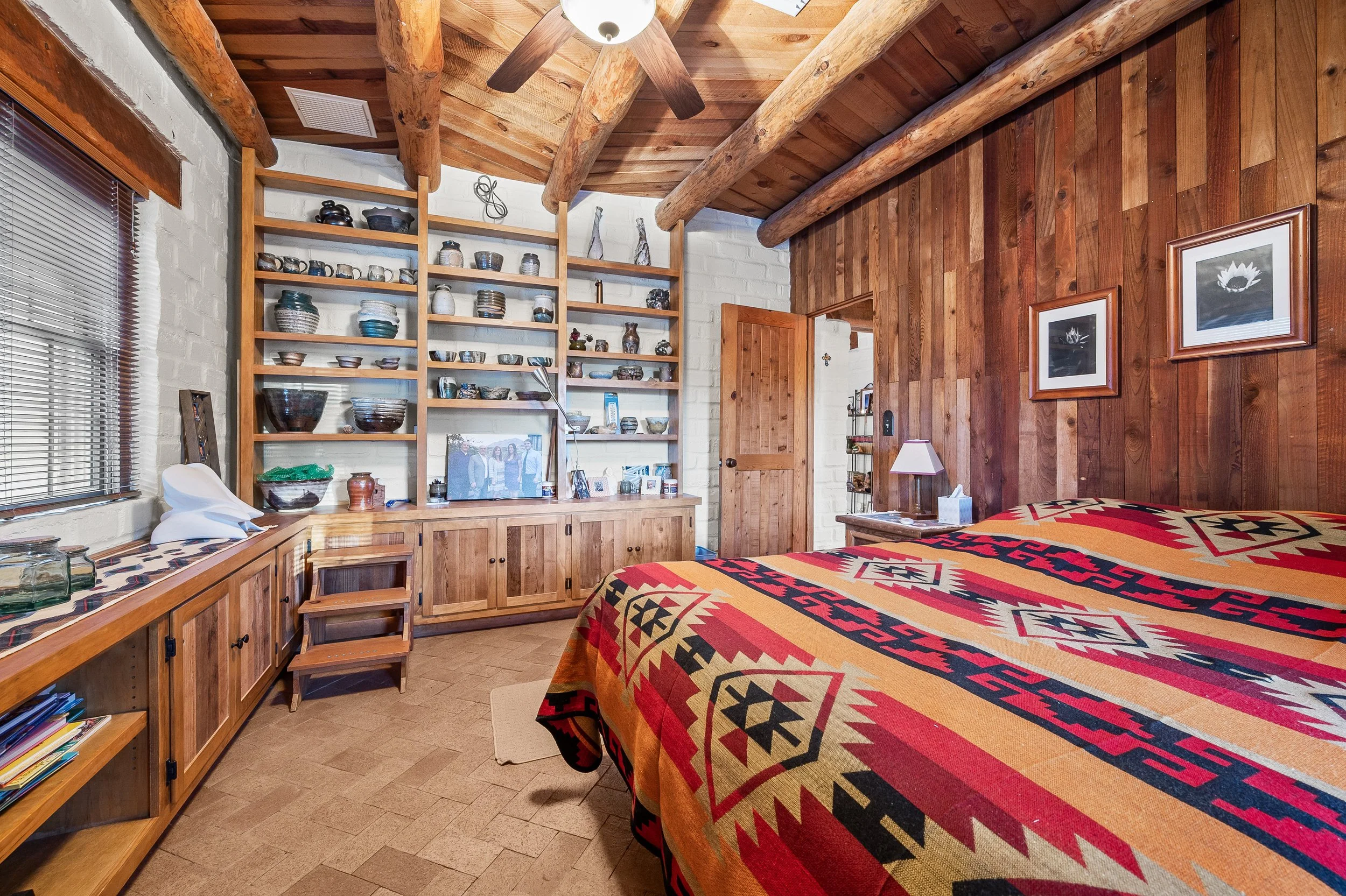hacienda bedroom with rustic beams and wood paneling