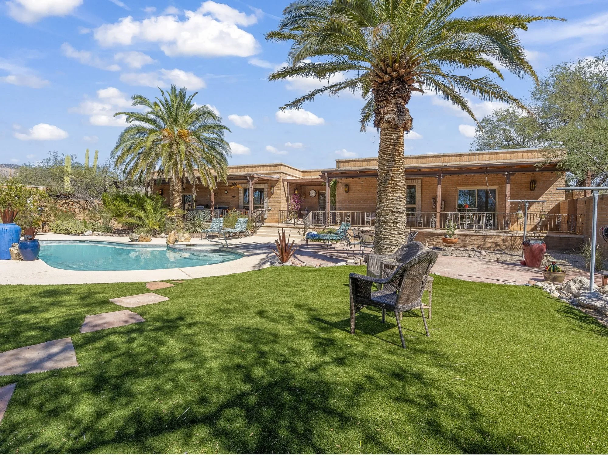 Backyard pool, palms and lawn at a Tanque Verde Valley horse property in Tucson, AZ sold by Oliver Realty