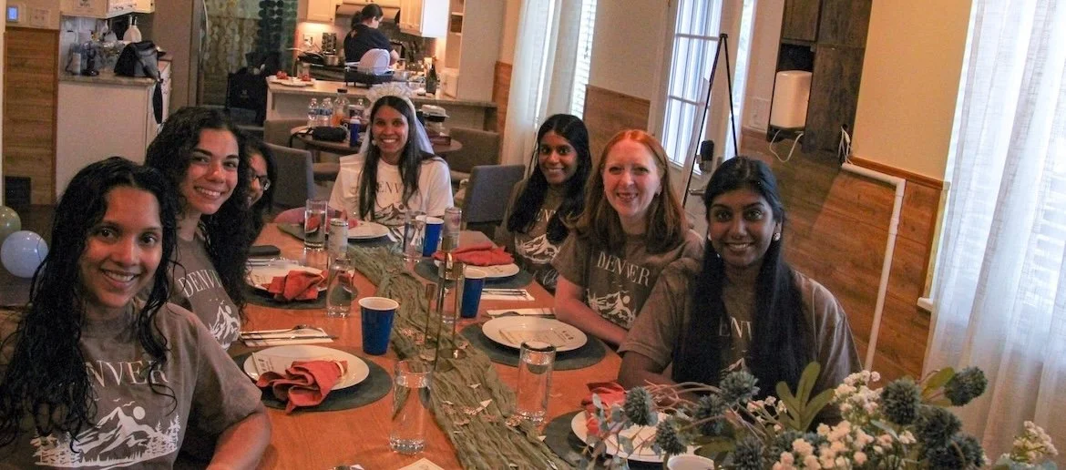 Friends celebrating a Denver bachelorette party with a private chef dinner at an Airbnb.