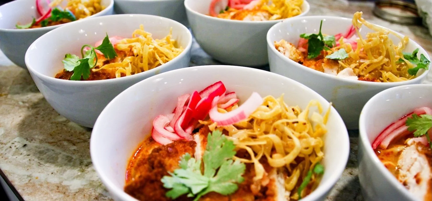 Chef-prepared Thai khao soi served at a private chef anniversary dinner in Denver, Colorado