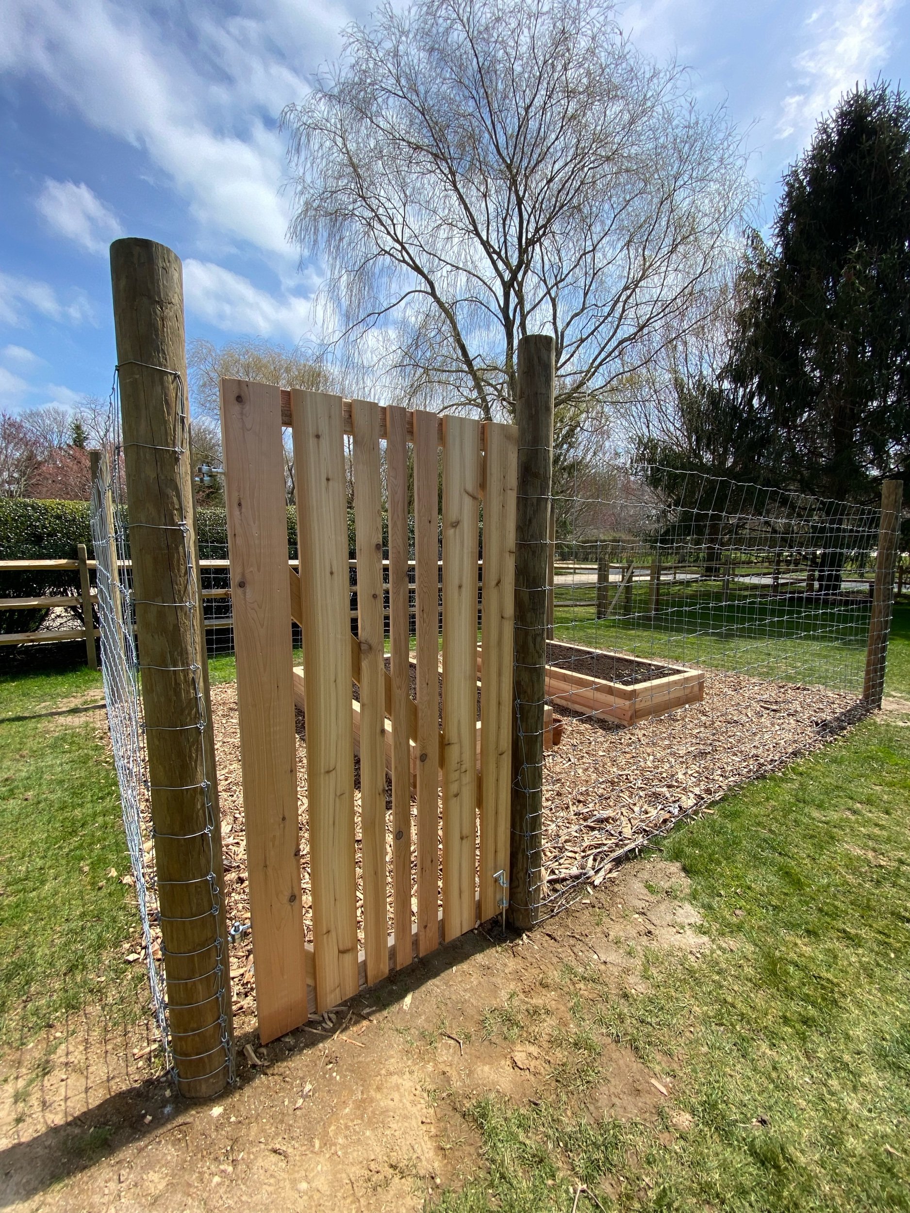 Ready-to-plant cedar raised bed, custom cedar gate, 6’ field fence