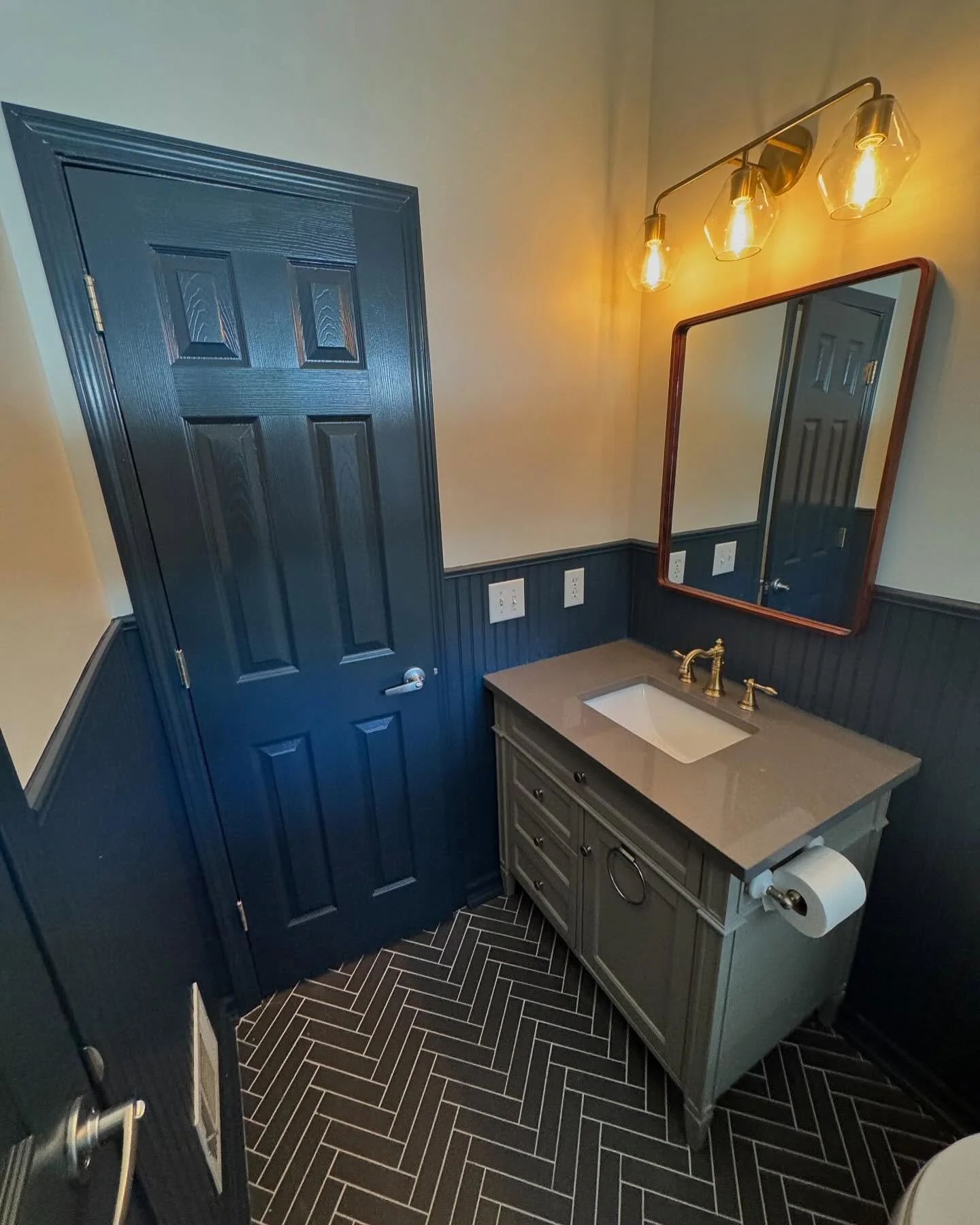✨ After a plumbing leak caused damage, our client needed a fresh start&mdash;and we delivered! This bathroom got a stunning makeover with classic wainscoting, tile, fresh paint, and updated fixtures while keeping the original vanity for a stylish and