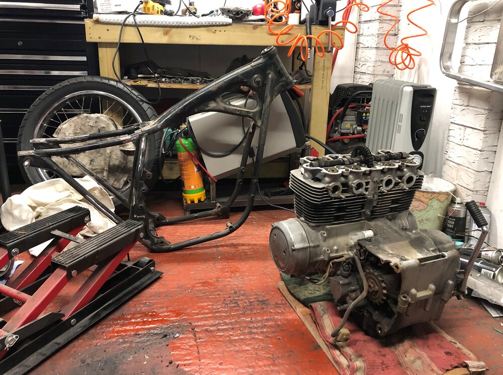 Ride the miles Honda CB550 engine removal on floor and frame.jpg