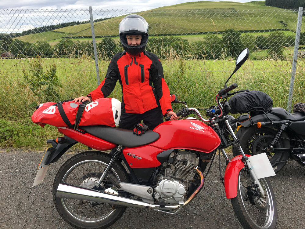 Lesley and her Honda CG 125 touring with tail dry bag
