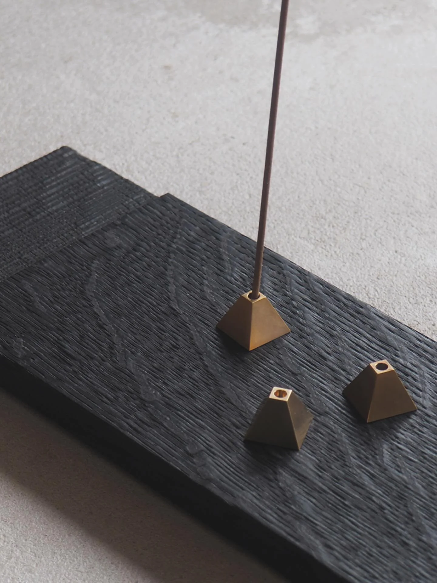Burnt Oak Plinth with Sawn Texture from our current collection. Perfect for serving small tea bowls, for serving small food bites like sushi, or displaying treasured objects like shells, stones or crystals.
Shown here with solid brass pyramid incense