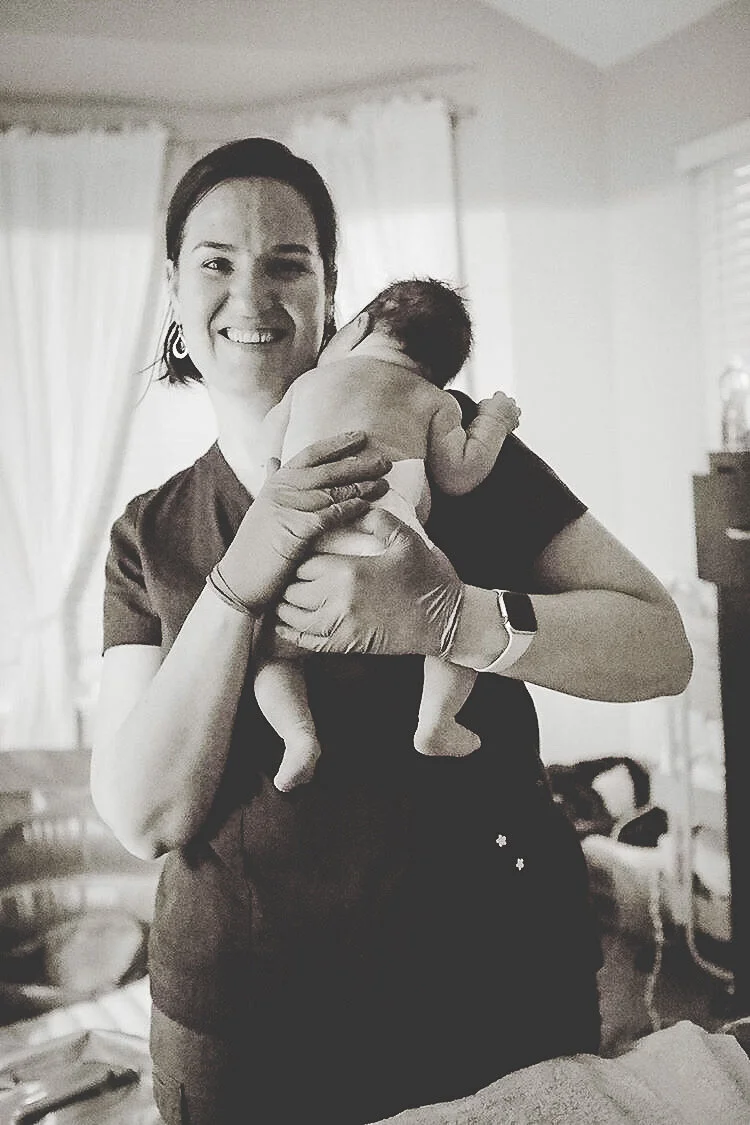 Kattie Jones, certified midwife, holding a newborn baby after Natural childbirth in denver