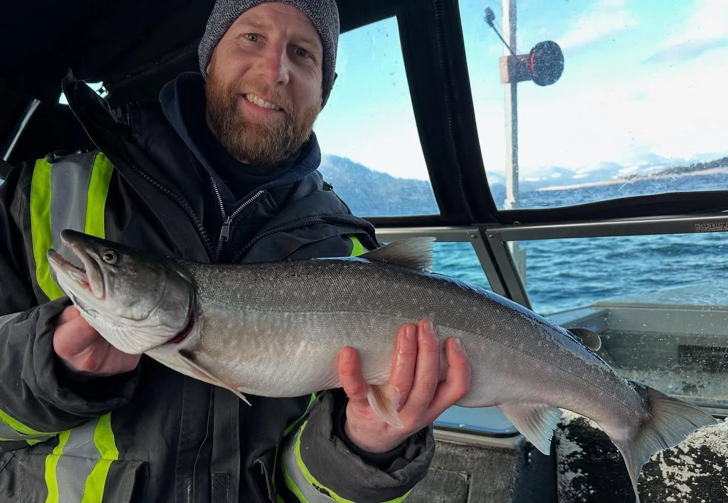 Happy guest with a decent bull trout for dinner. #bulltrout #nakusp #fishingtrips #winteradventures #winterfishing #getoutside #fishingismylife #fishingcharter #arrowlakes