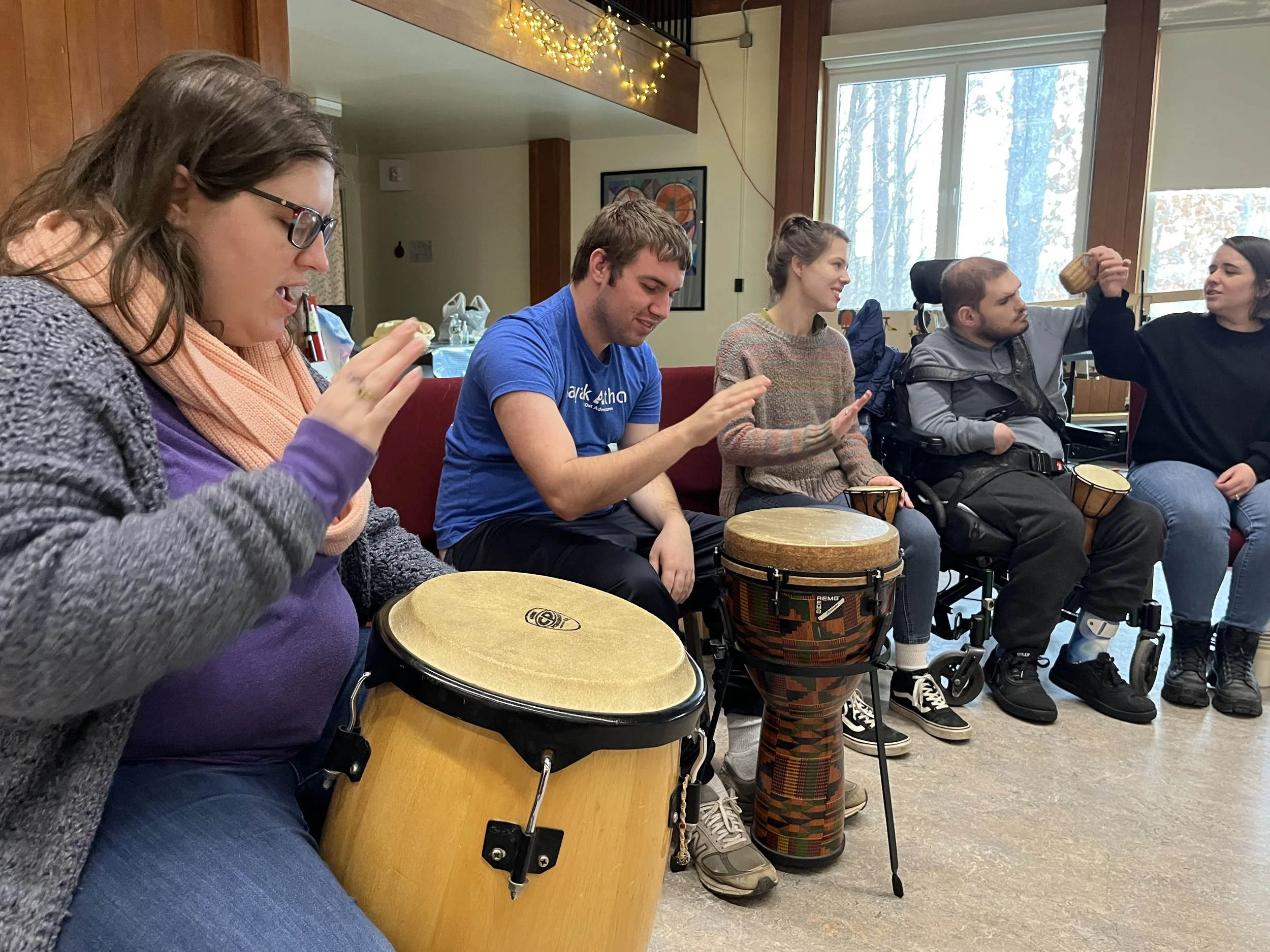 Troupe members were captured sitting side by side playing drums together.