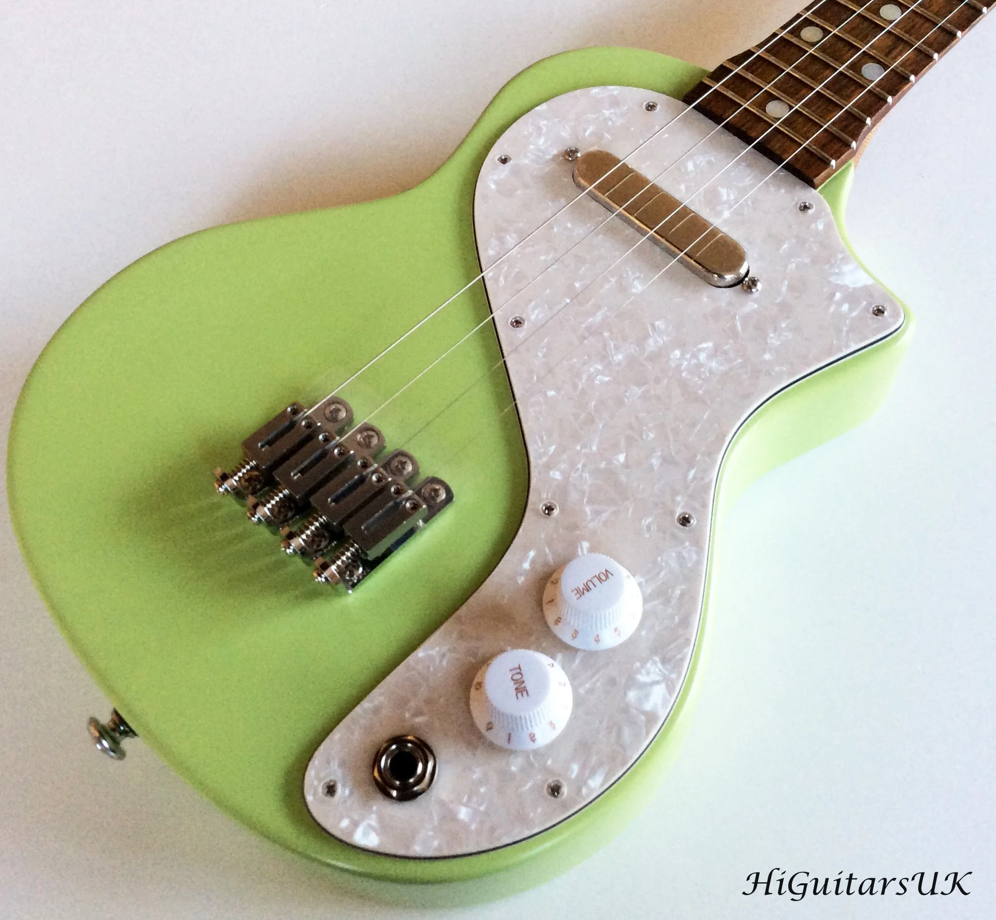 Green electric concert ukulele close up - HiGuitarsUK