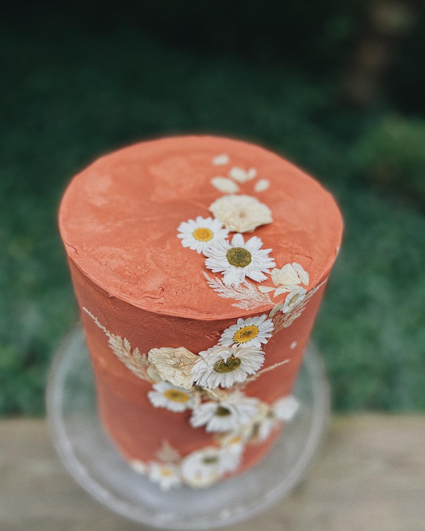 little raspberry lemon cutting cake covered in rust buttercream &amp; dried pressed flowers