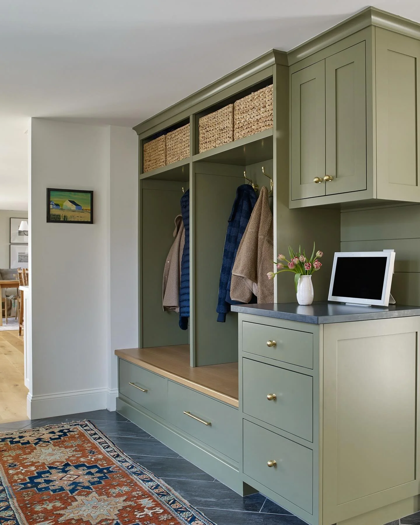 A reminder that functional spaces deserve thoughtful design too. With custom cabinetry, a mix of open and concealed storage, a hidden charging drawer and integrated counter space, this Mudroom proves everyday functionality can still feel refined, war