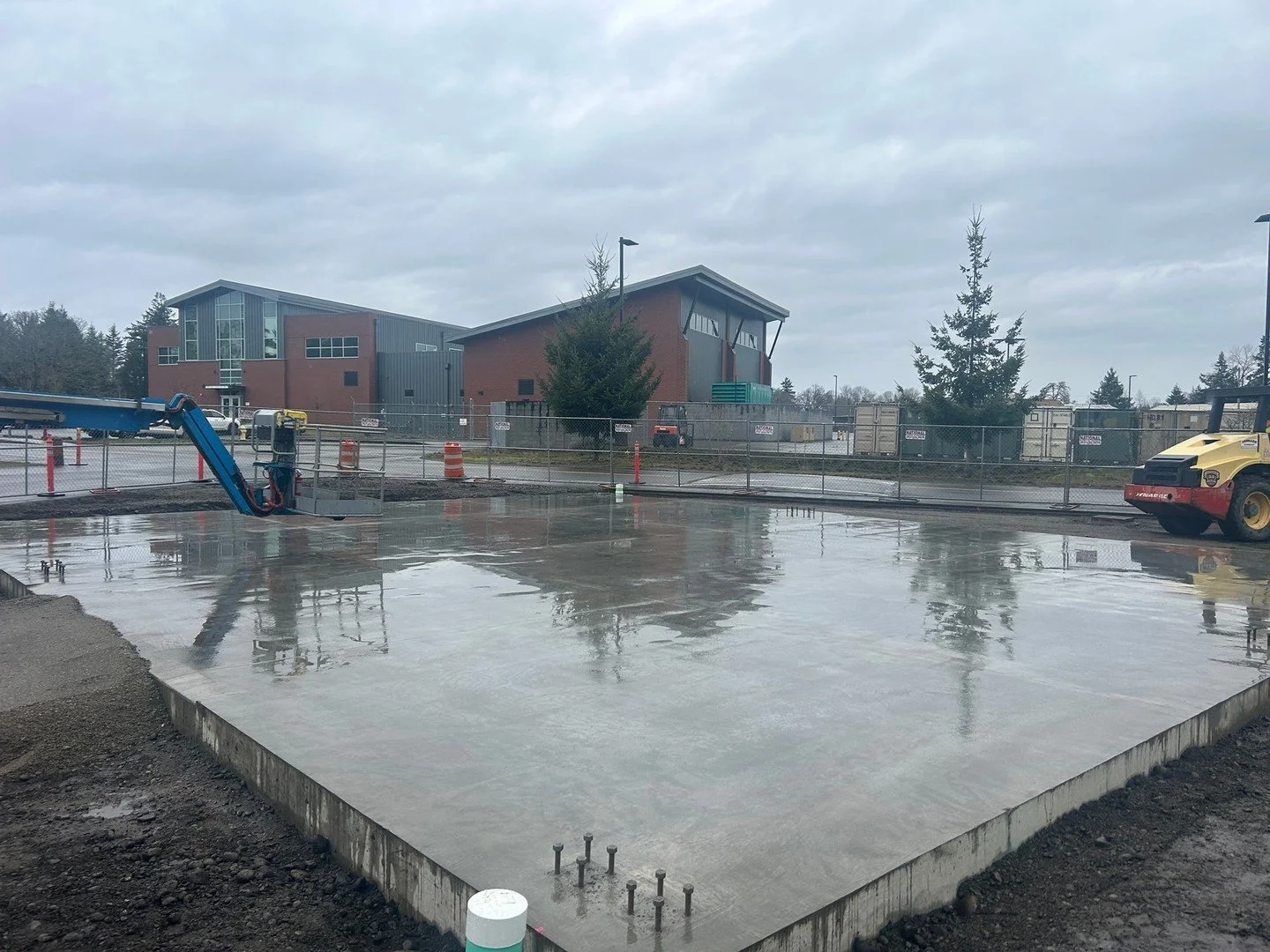 Lots of progress underway at the Camp Murray Military CST Ready Building! The concrete slab is complete and backfilled, ready for the Pre-Engineered Metal Building. Rain or shine, our crew gets it done 🌦️