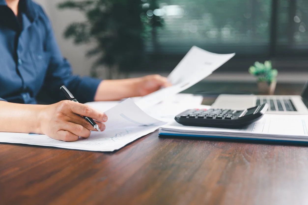 Woman at desk looking at papers for tax planning