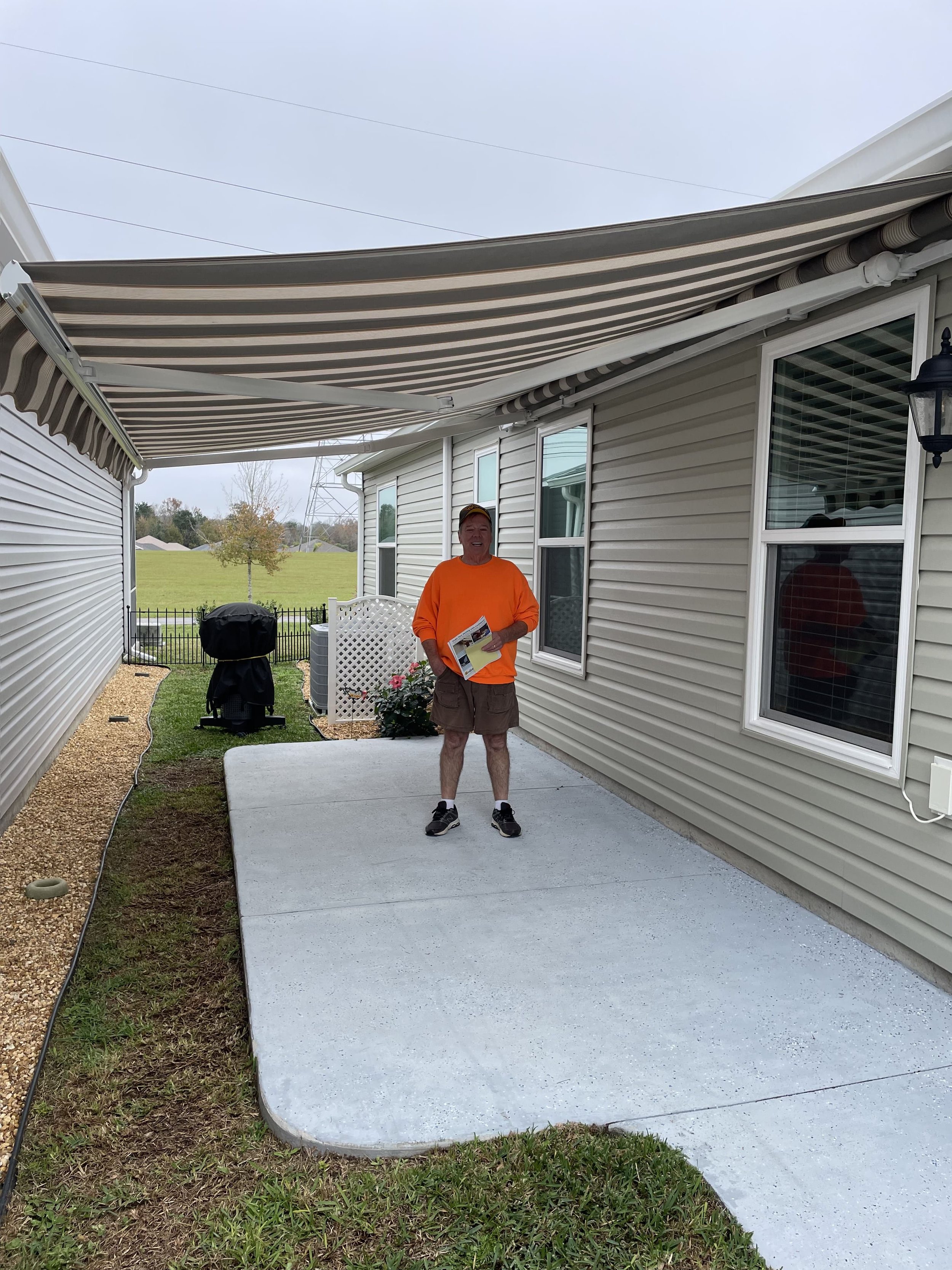 A happy customer in the villages under their newly installed awning.