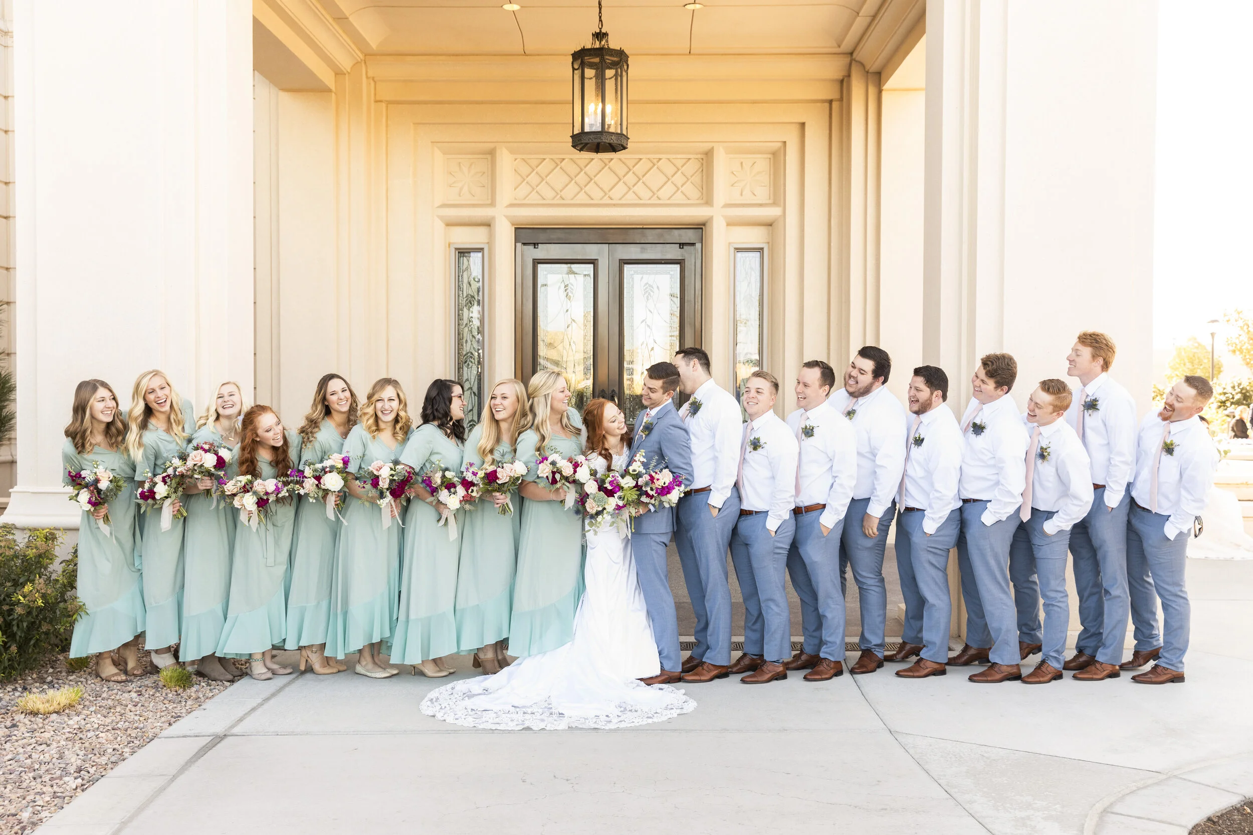  wedding party at the temple doors beautiful modest brides maids dresses summer grooms men attire inspiration wedding party attire inspiration ideas and goals lds wedding picture goals all together looking at each other pose inspiration joyful day ev